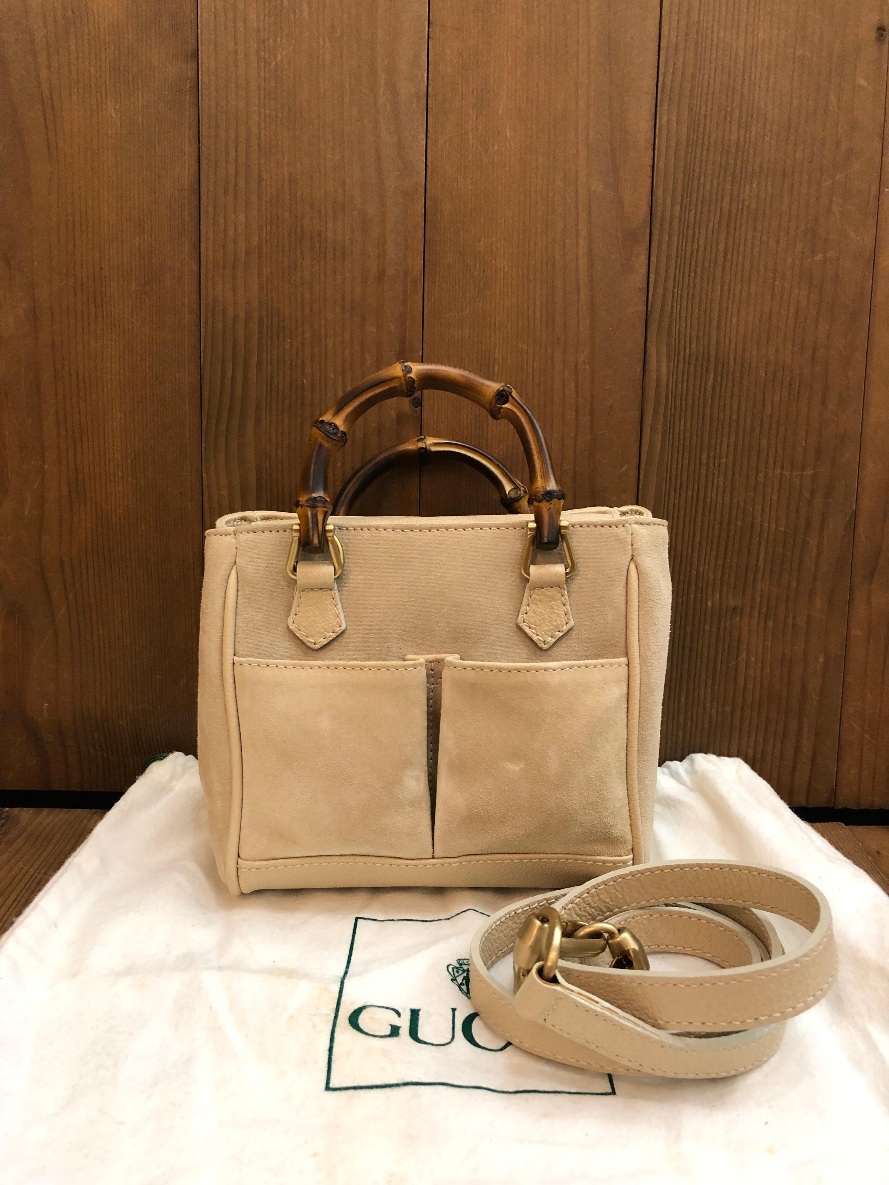 This 1990s vintage GUCCI mini 2-way bamboo crossbody bag is crafted of pigskin and nubuck leather in beige featuring gold toned hardware and bamboo handles. The front of this bag features two open pockets. Top magnetic snap closure opens to a beige