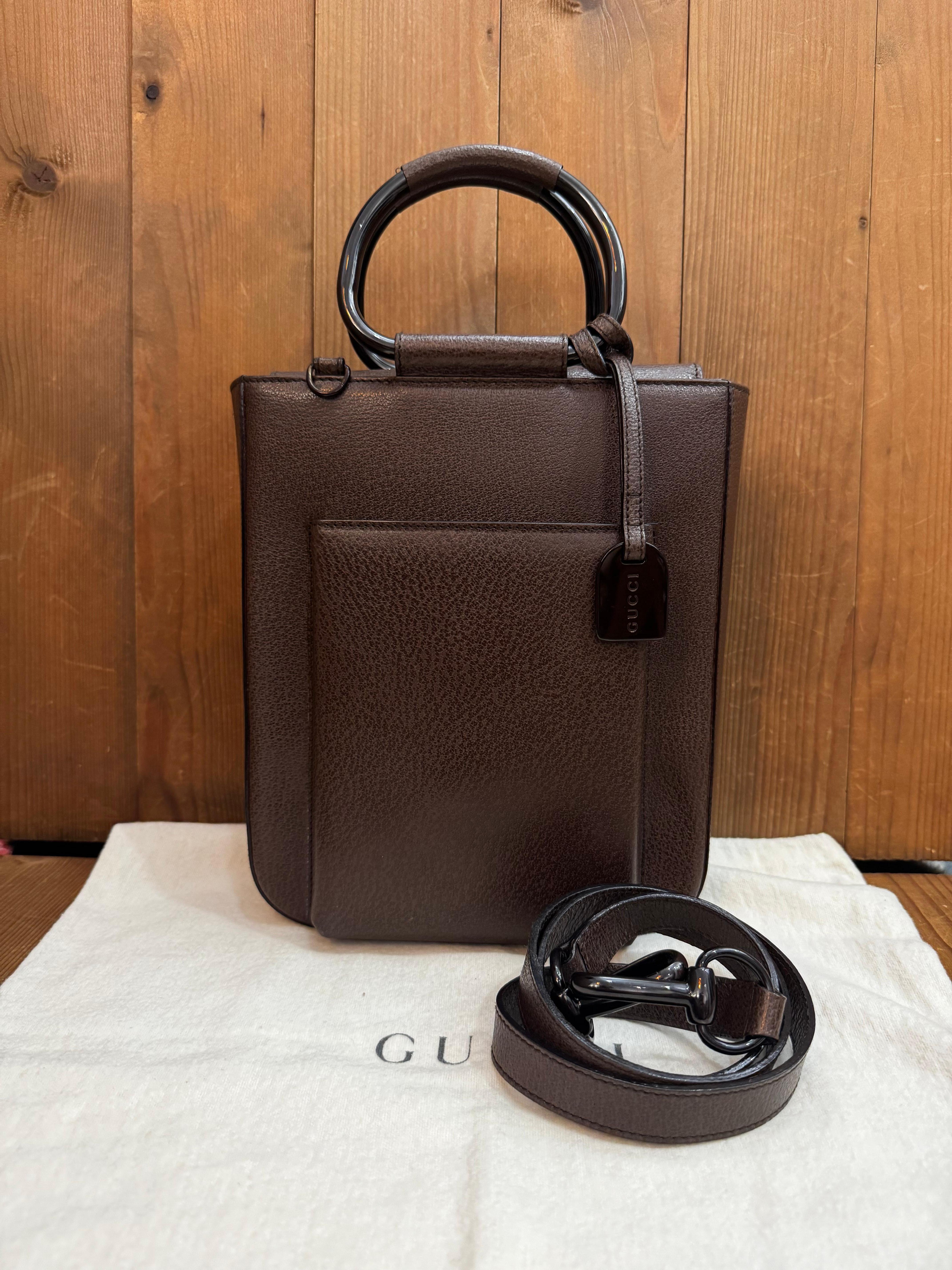 This vintage GUCCI tote bag is crafted of pigskin leather in chocolate brown featuring enameled hardware in brown and rolled leather metallic handles. Top magnetic snap closure opens to a coated interior which has been professionally cleaned
