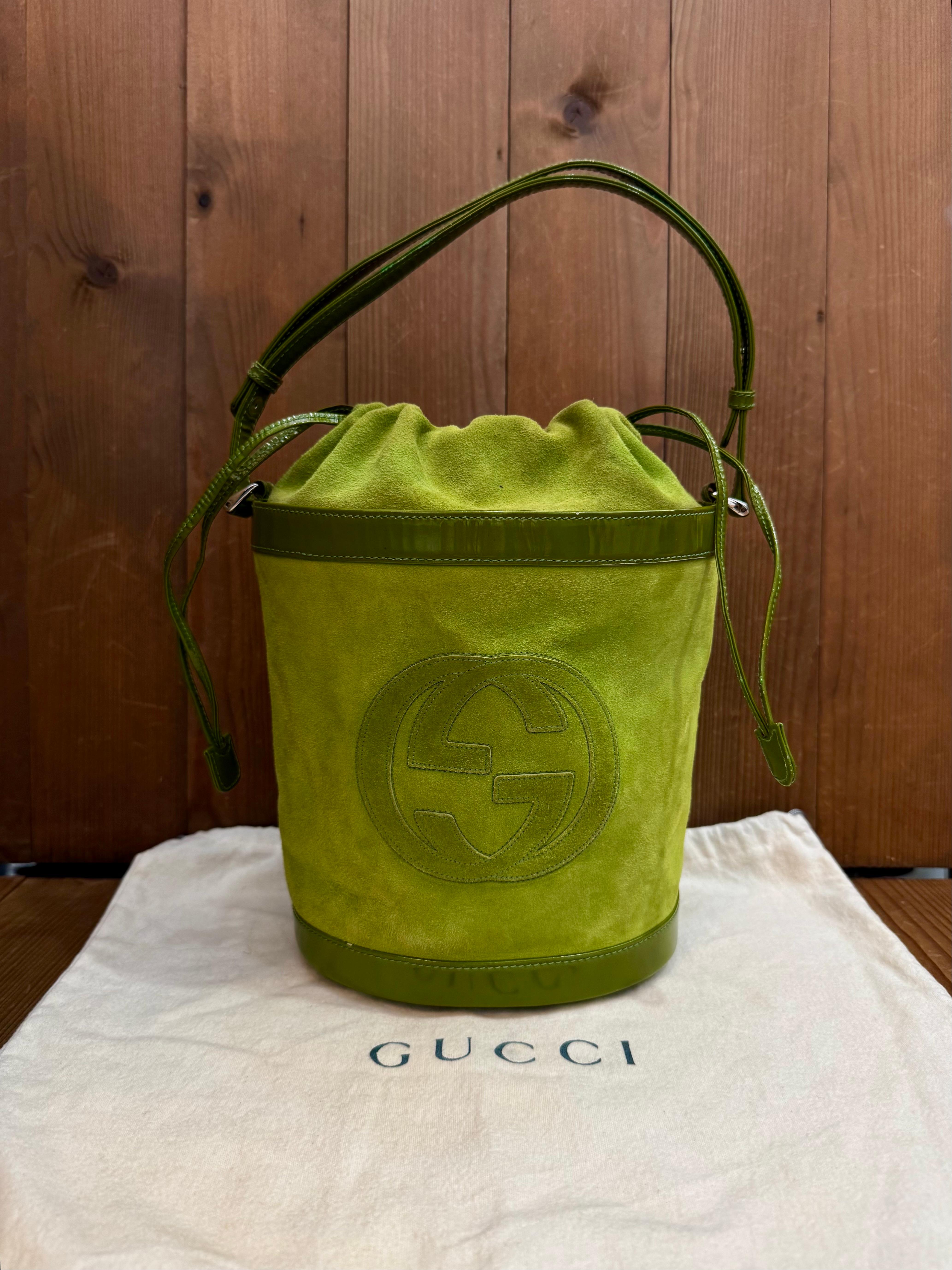 This vintage GUCCI two-way bucket bag is crafted of suede and patent leather in lime green. Top drawstring closure opens to a coated interior which has been professionally cleaned featuring a zippered pocket. This Gucci features an adjustable strap