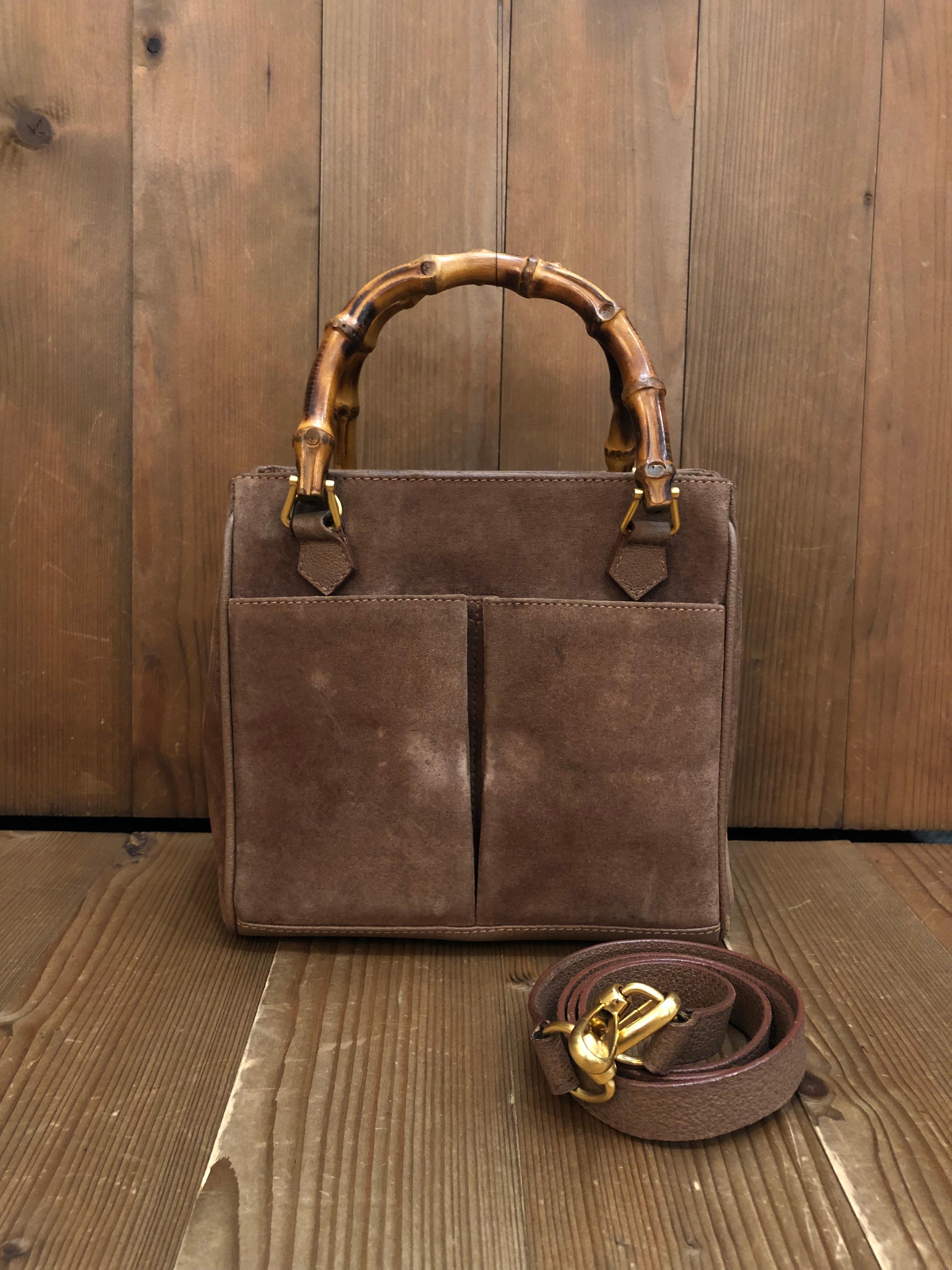 This vintage GUCCI 2-way bamboo crossbody bag is crafted of pigskins and nunuck leather in brown featuring matte gold toned hardware and bamboo handles. The front of this bag features two open pockets lined with diamanté jacquard. Top magnetic snap
