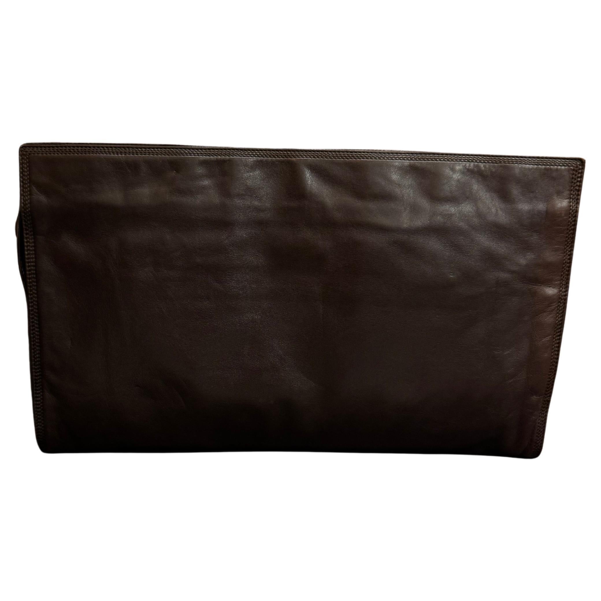 This vintage LOEWE XL clutch bag is crafted of soft smooth calfskin leather in chocolate brown. Top zipper closure opens to a coated interior which has been professionally cleaned with a zippered pocket. The front of this clutch also features a slip