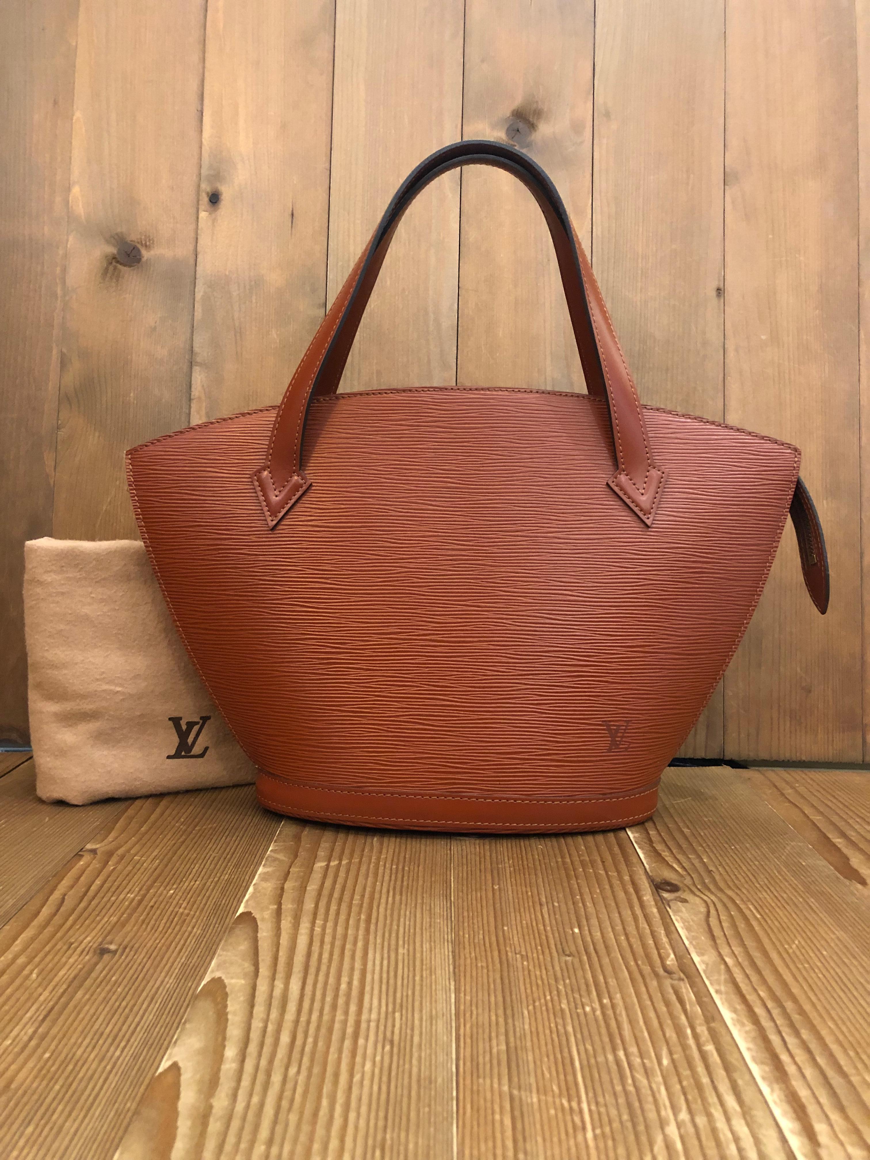 This Vintage LOUIS VUITTON Saint Jacques PM tote bag is crafted of LV signature Epi leather in brown and smooth brown leather. Zipper top closure opens to a brown microfiber interior with one zippered pocket for your daily essentials. Made in France