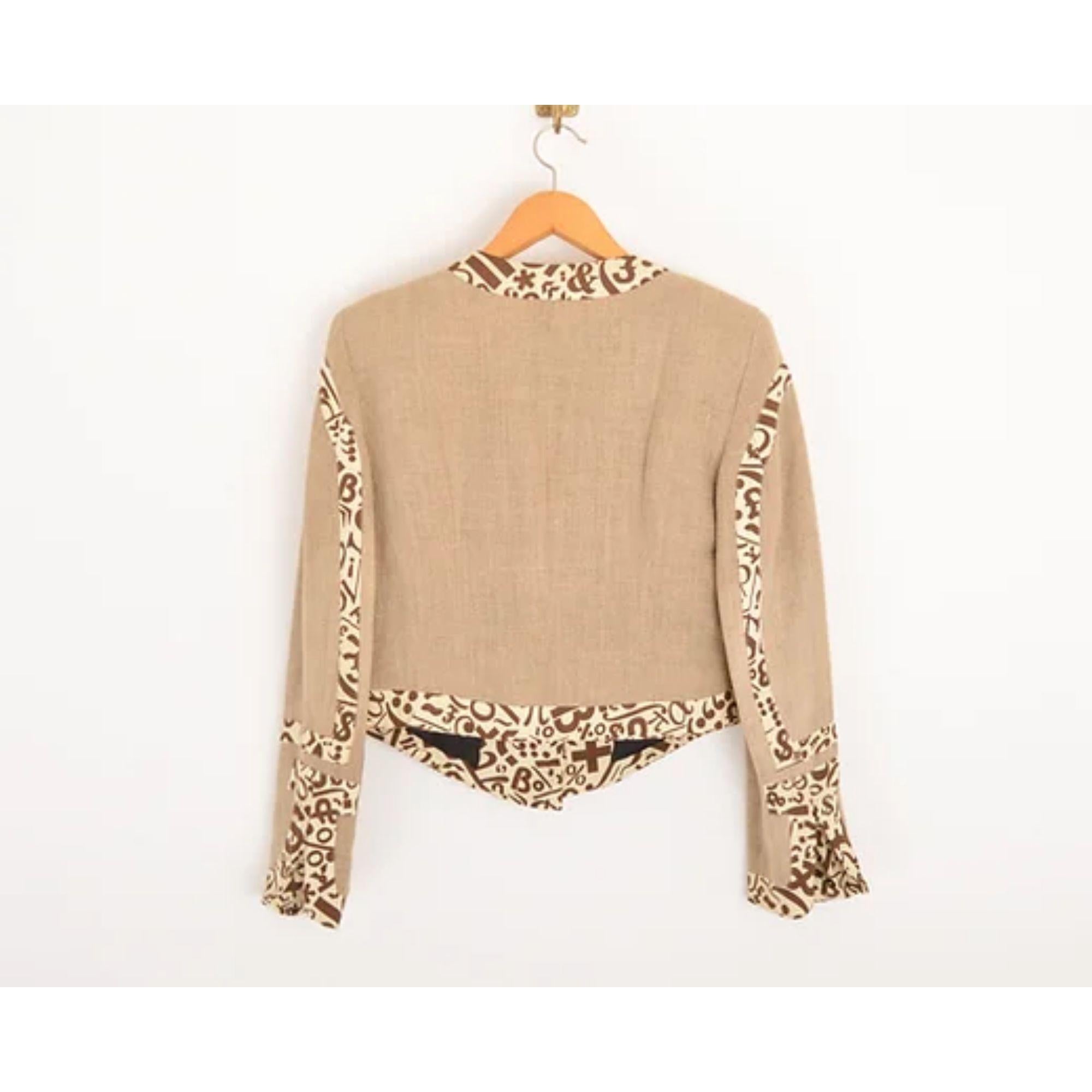Vintage 1990's Moschino Cheap & Chic label Linen boucle style jacket with playful breast shaped panelling in a cream and brown punctuation print. 

MADE IN ITALY !

Features:
Central line button fasten
'Lets Love Eachother' embossed buttons
Boucle