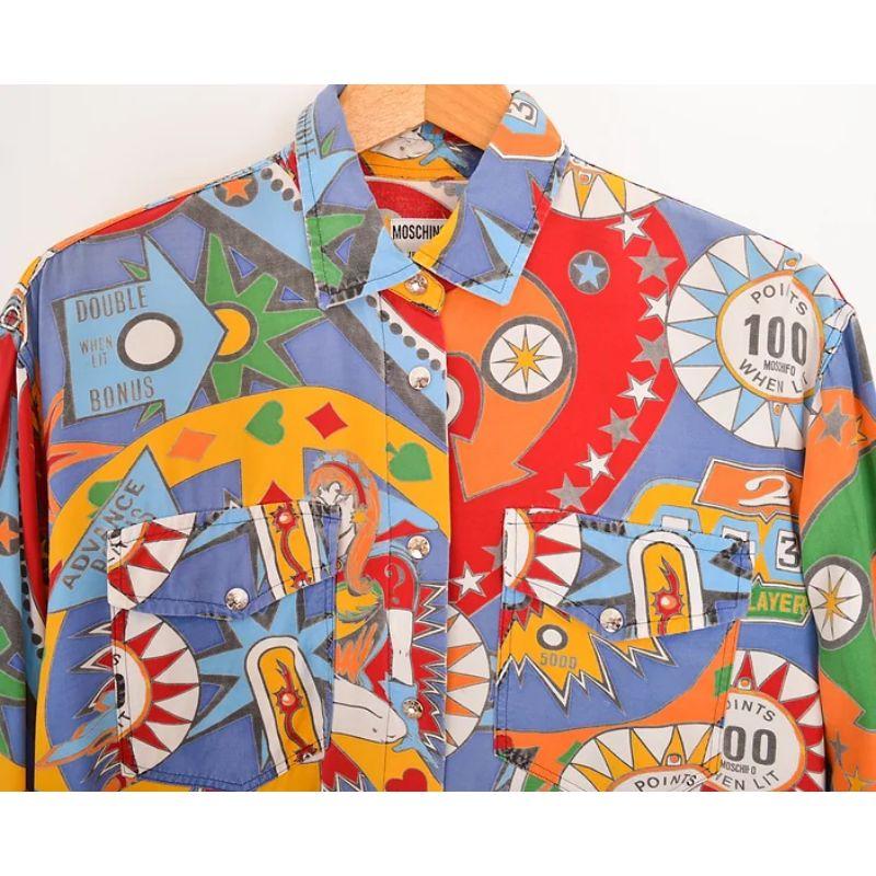 Vibrant, Vintage 1990's Moschino 'Pinball' patterned long sleeve, button down shirt. 

MADE IN ITALY !

Features:
Central line press stud button fasten
Long sleeves
Chest pockets
Oversized fit

100% Rayon

Sizing given in inches: 
Pit to Pit: