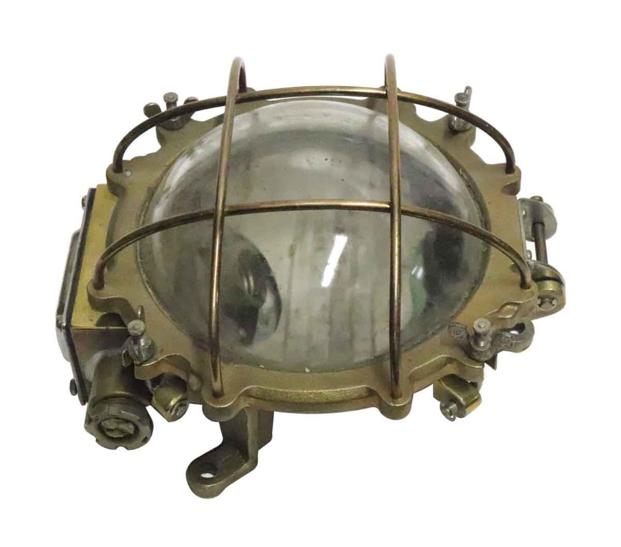 Vintage nautical brass hallway ship light with a caged round glass area for the light to shine through. From the 1990s. Price includes restoration. This can be seen at our 333 West 52nd St location in the Theater District West of Manhattan. 