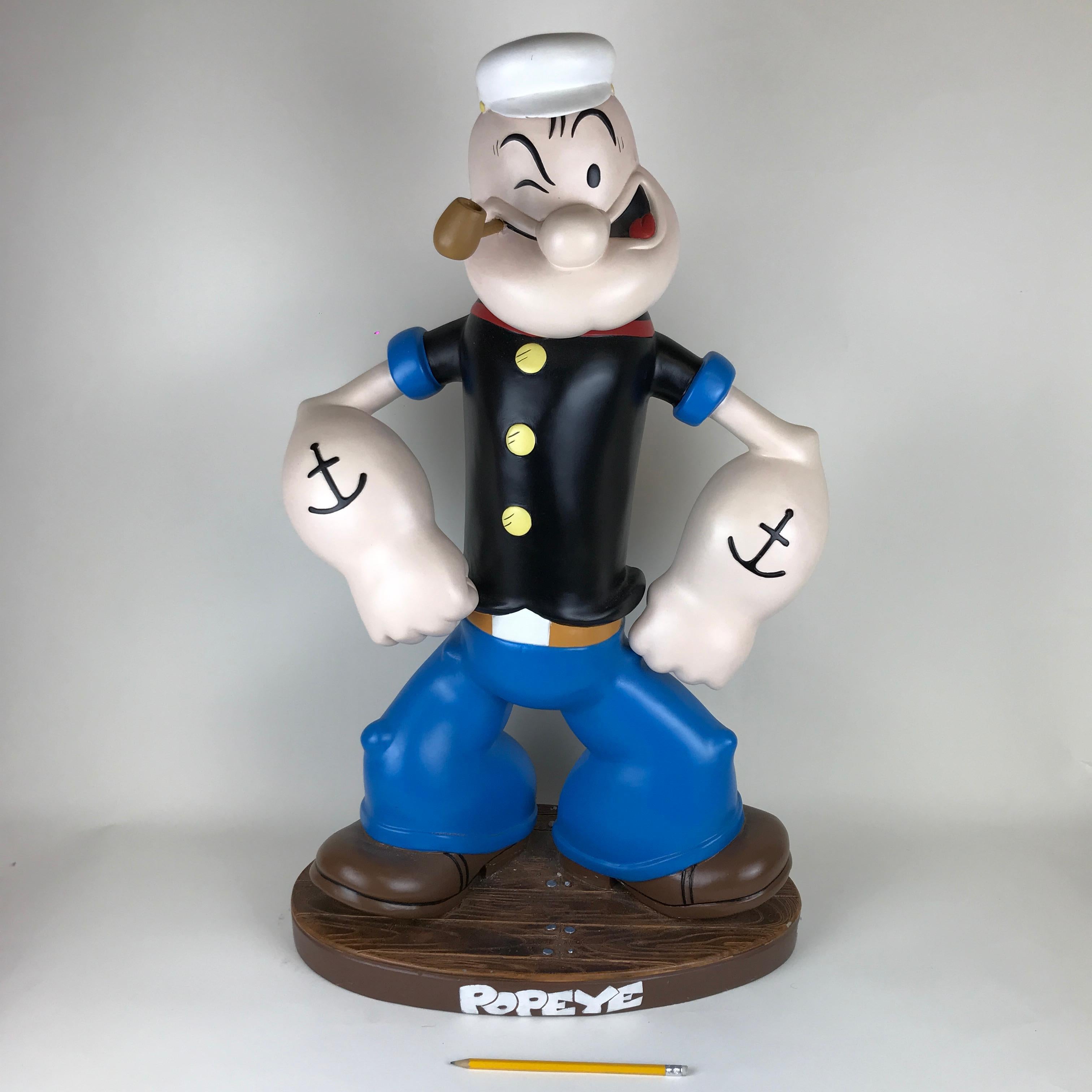 2019 marks the 90th birthday of the famed comic character Popeye the Sailor.

This vintage original Popeye the Sailor with pipe resin sculpture sits on a base with the name Popeye on the front, and was made in the 1990s in the USA.

The back of