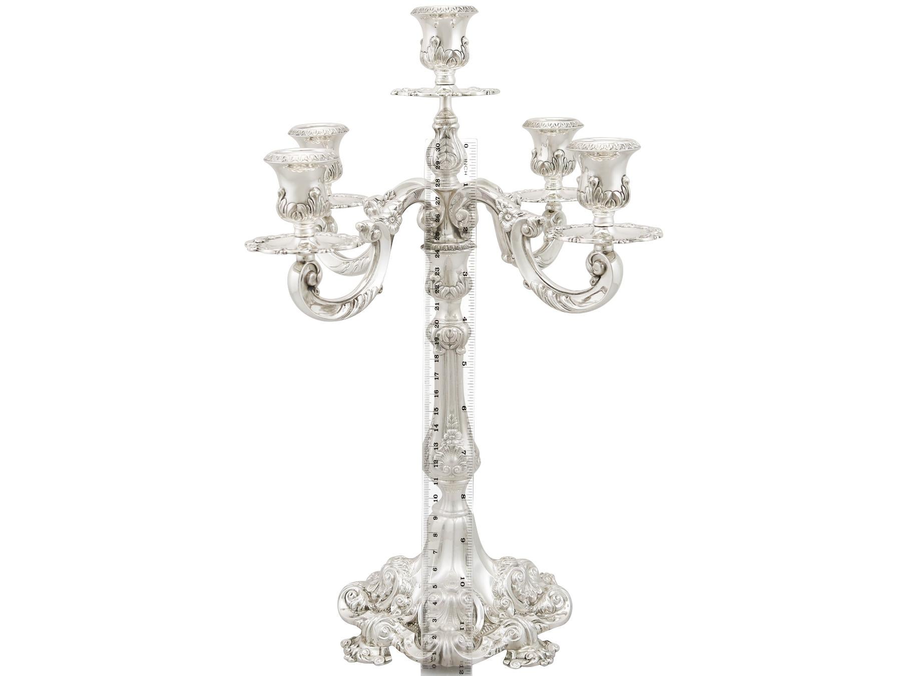 This exceptional vintage Portuguese sterling silver five light candelabrum has a waisted shaped form.


This silver candelabrum retains the original hallmarked detachable silver screw fit arms.


The cast sterling silver opposing scrolling