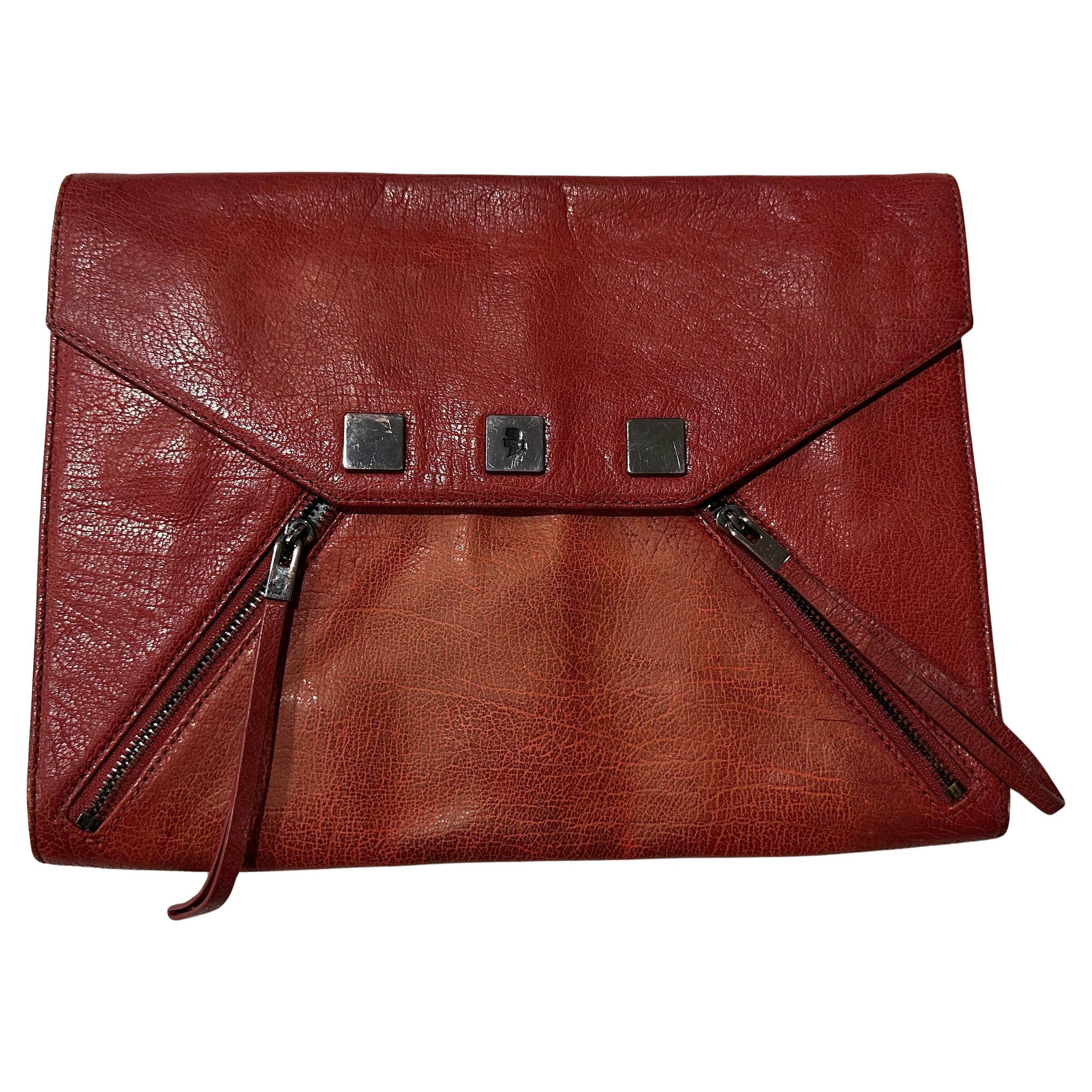 A timeless elegant Karl Lagerfeld red leather envelope clutch bag, straight from the iconic designer's 1990s collection. This piece is a true testament to Lagerfeld's visionary style, blending classic sophistication with a touch of edgy