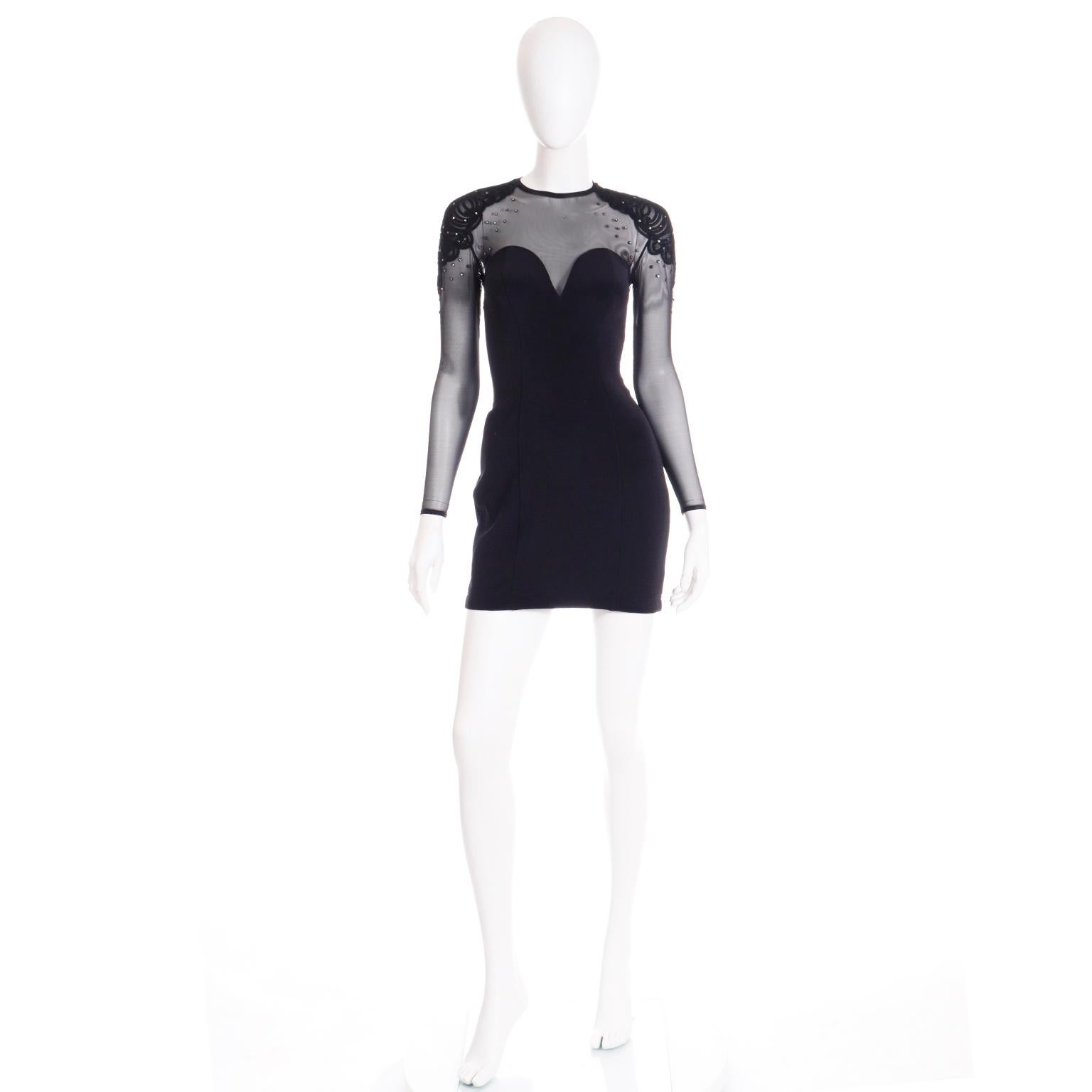 We always love vintage Tadashi evening dresses and this fun bodycon dress is a great example of his talent! This fun dress has the signature illusion bodice with sheer mesh continuing down the long sleeves. The shoulders are embellished with black