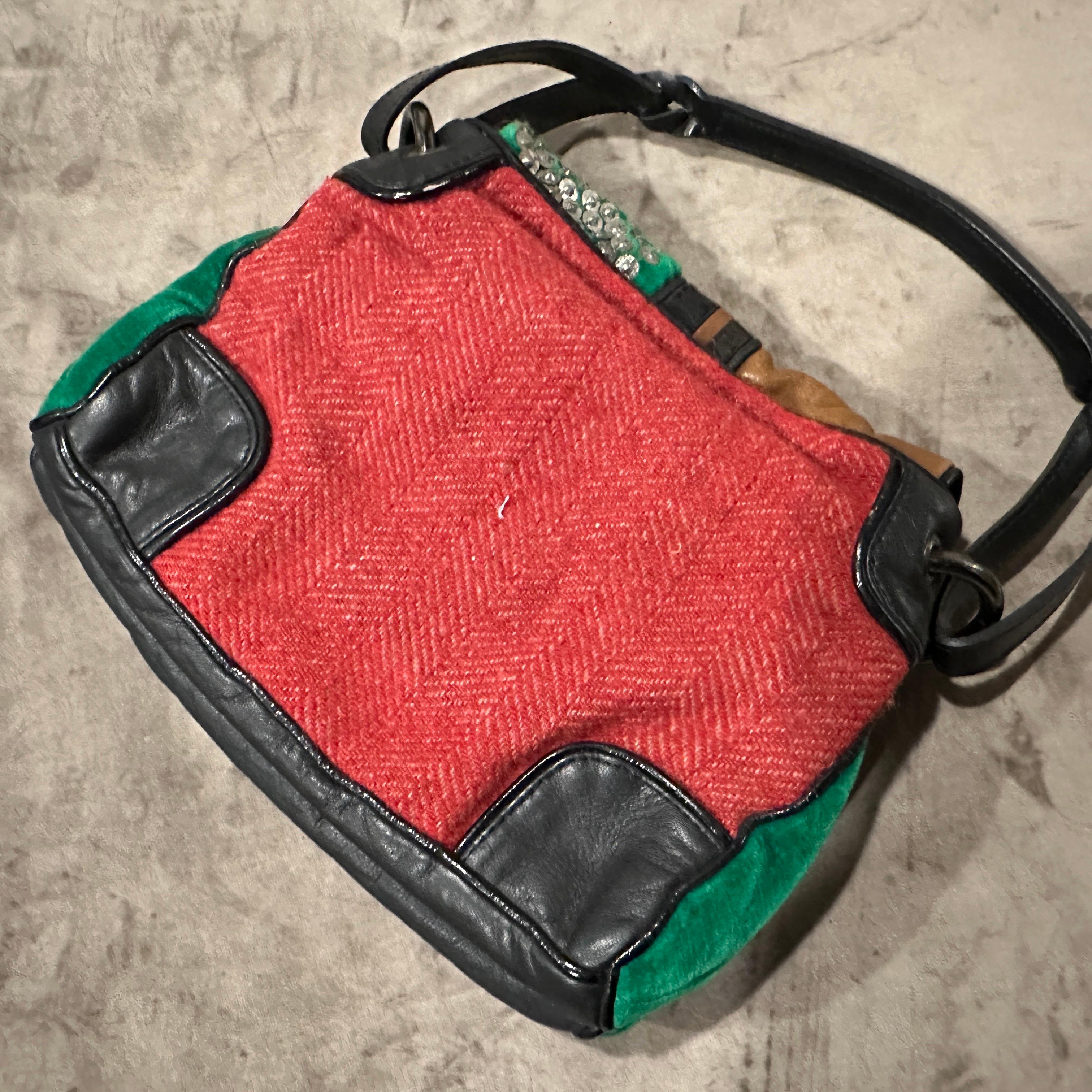 This one-of-a-kind vintage handbag by Jamin Puech is a true collector's item, showcasing the brand's signature eclectic and artistic style. Dating from the 1990s, this top-handle bag is a textural and visual masterpiece, combining various materials
