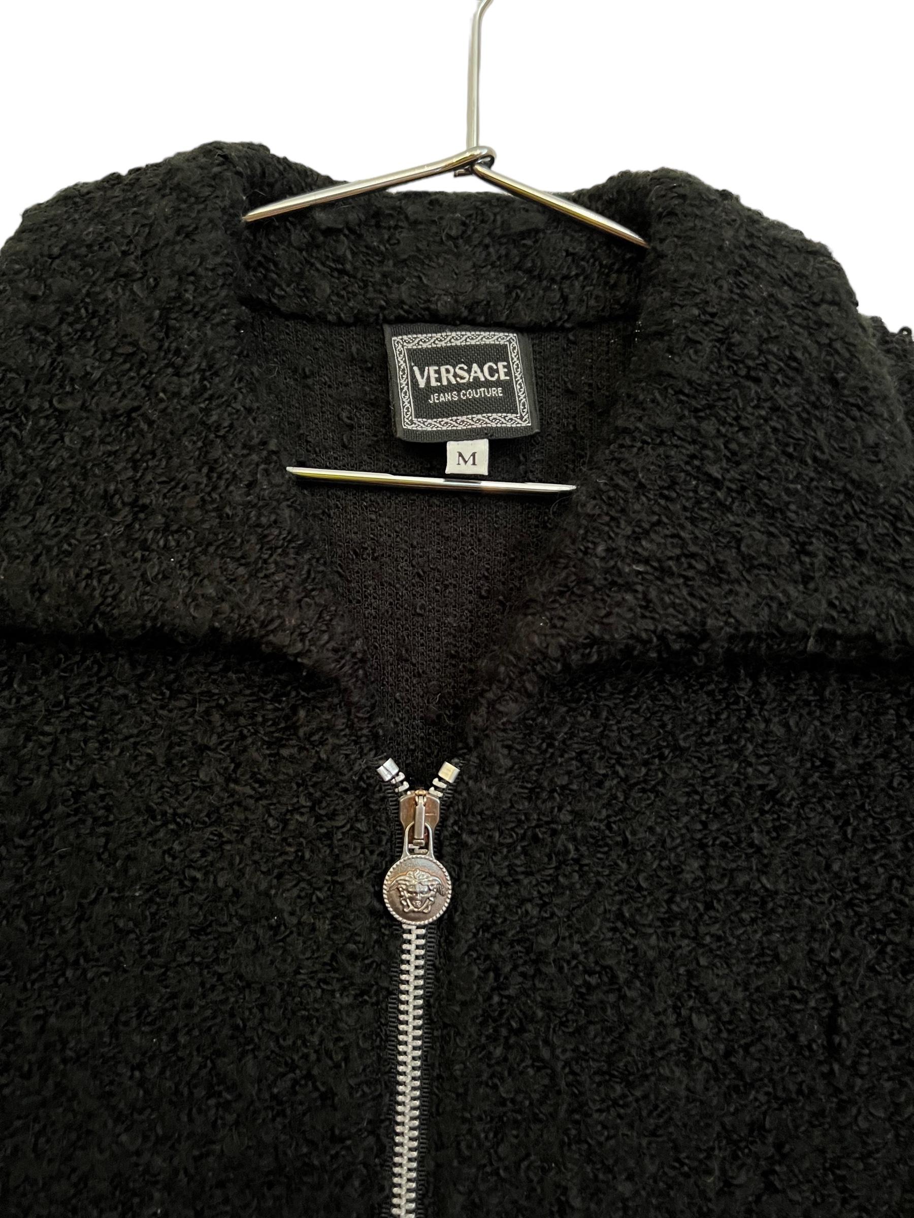 Chic Vintage early 1990's Versace Jeans Couture Cropped Cardigan, in a Fuzzy black textured material with silver metal hardware and iconic Medusa details.

Features: 
Zip down front
waist pockets 
Long Sleeves
Piece N0* 490631
Japanese