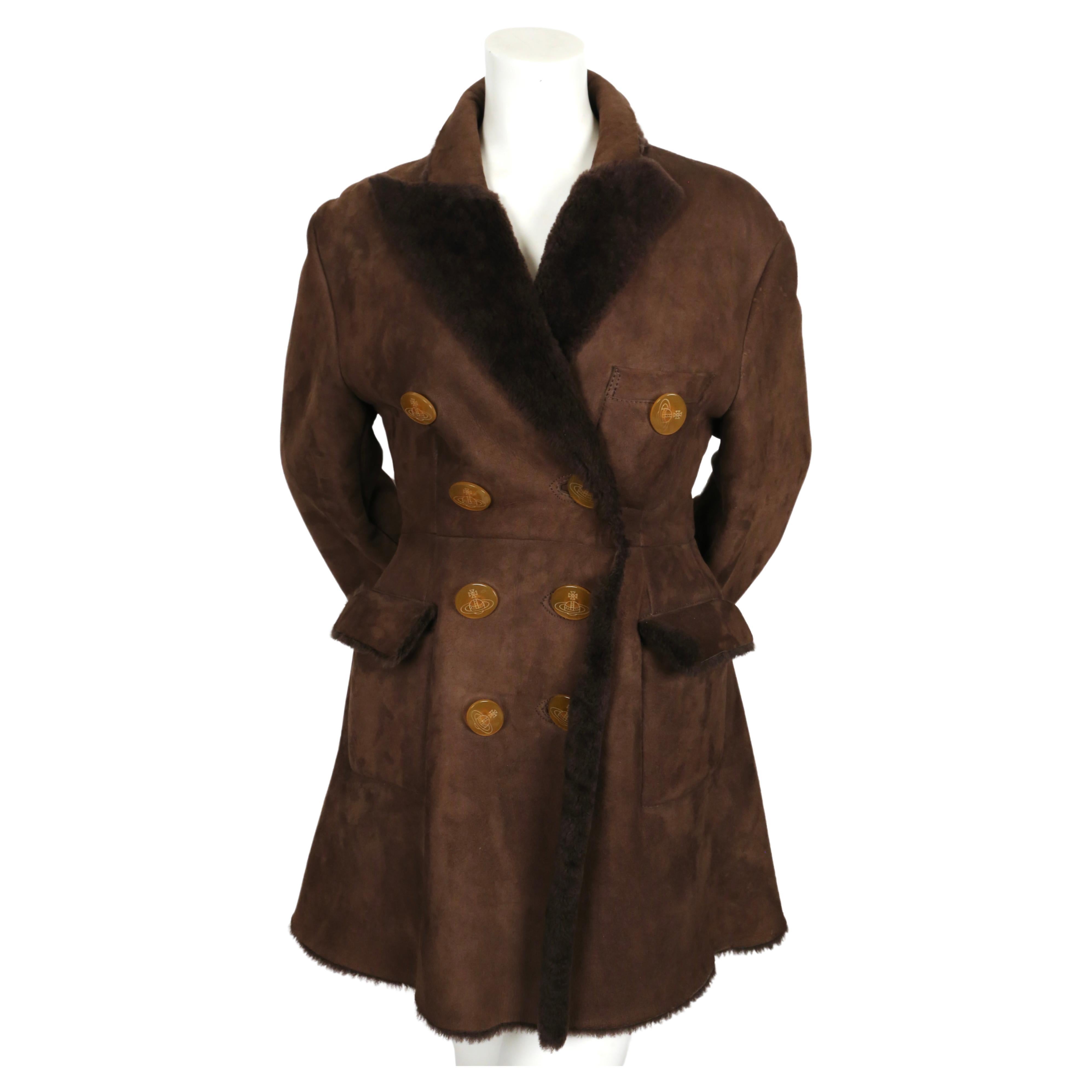 Rich, brown shearling coat with signature orb buttons designed by Vivienne Westwood dating to the mid 1990's.  Coat has a really great silhouette with its tailored 'Victorian' fit and flared back.  Coat is labeled an Italian size '44', however it