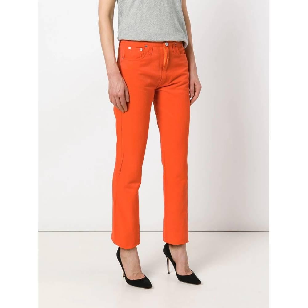 Walter Van Beirendonck medium waist in orange cotton blend jeans, button and zip closure and applied lightning bolt, three front and two rear pockets with decorative stitching.

The item shows slight signs of wear on the bottom and on the right leg