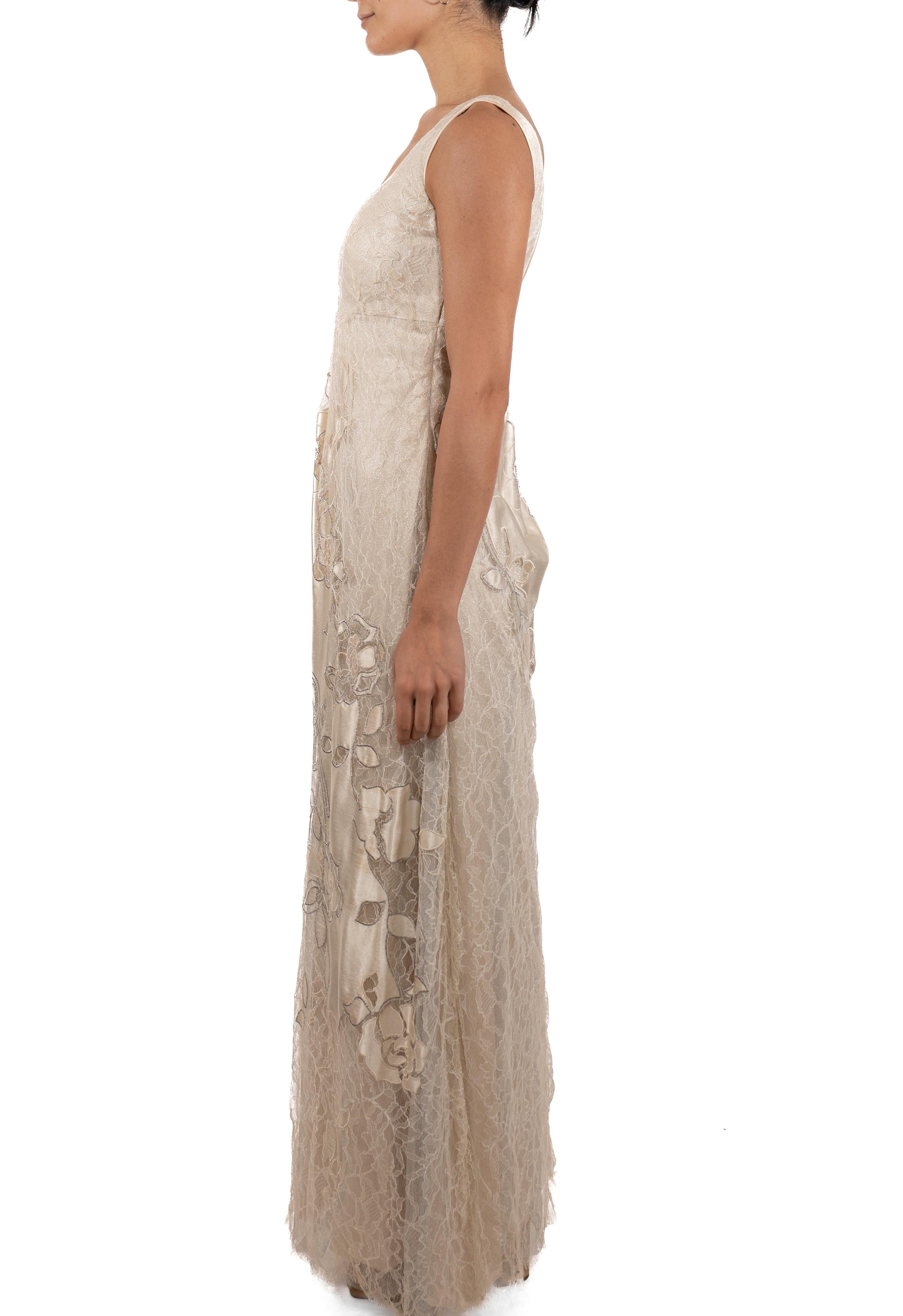 This gown retains no label, however the amount of hand-finishing points to Haute Couture or custom made quality, fully lined in silk. 1990S White & Silver Metallic Silk Chantilly Lace Empire Waist Gown With Satin Appliqué Flowers 