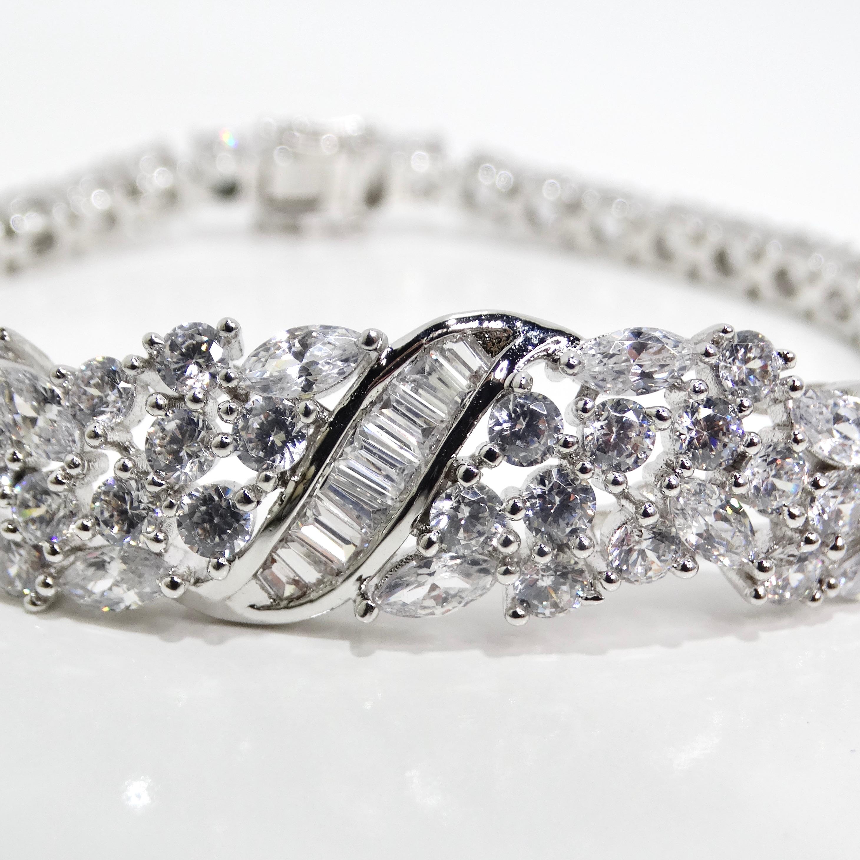 Step into the opulent world of the 1990s with the Art Deco Silver Rhinestone Bracelet, a captivating accessory that exudes the glamour and sophistication of the iconic Art Deco era. This incredible bracelet showcases a breathtaking design, featuring