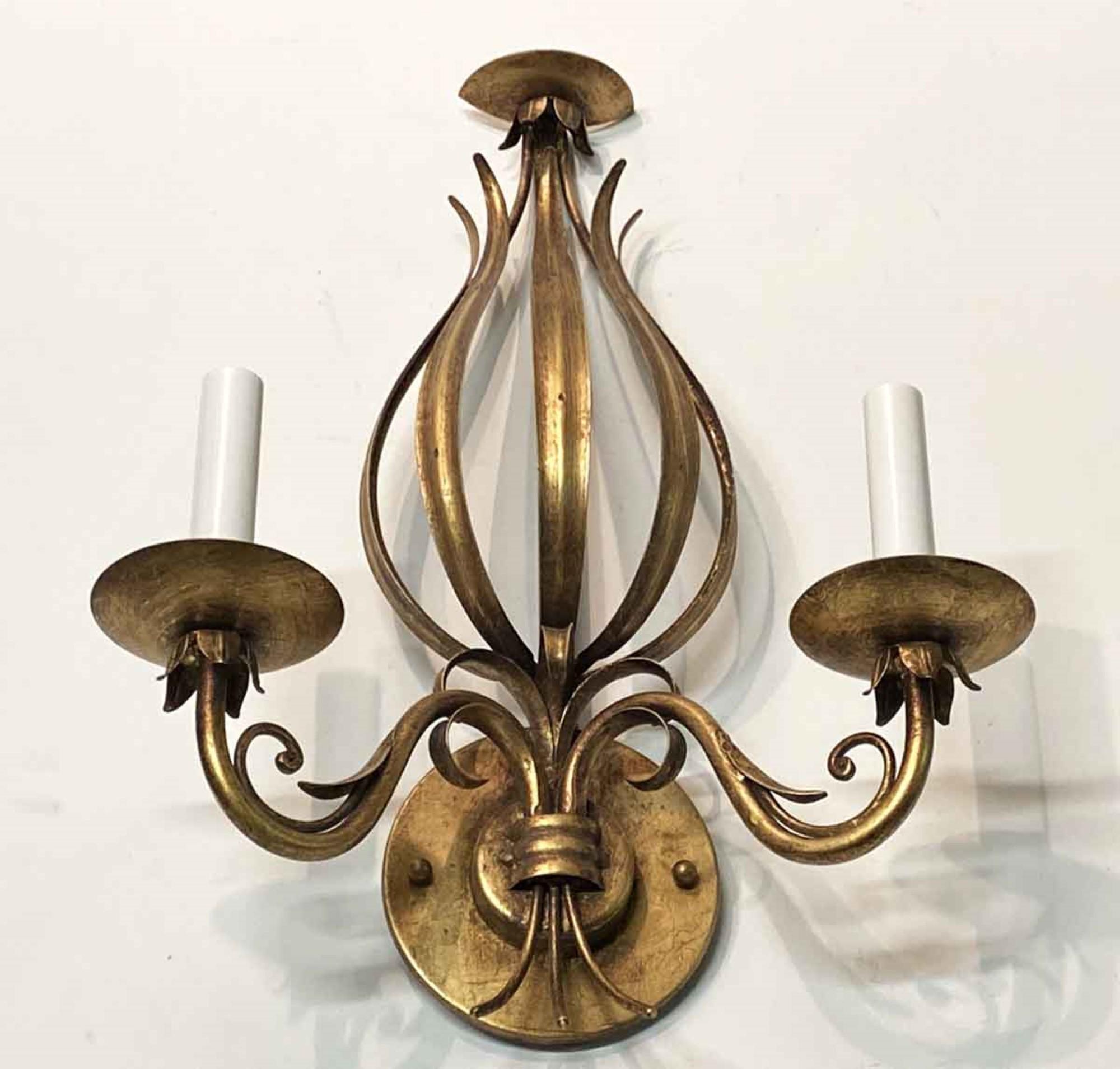 1990s handwrought iron Florentine style sconce with a gold gilt finish and two arms. Accepts two 60 w. candelabra bulbs. Also available in silver gilt finish. This can be viewed at our Scranton, Pennsylvania location. Please inquire for the exact