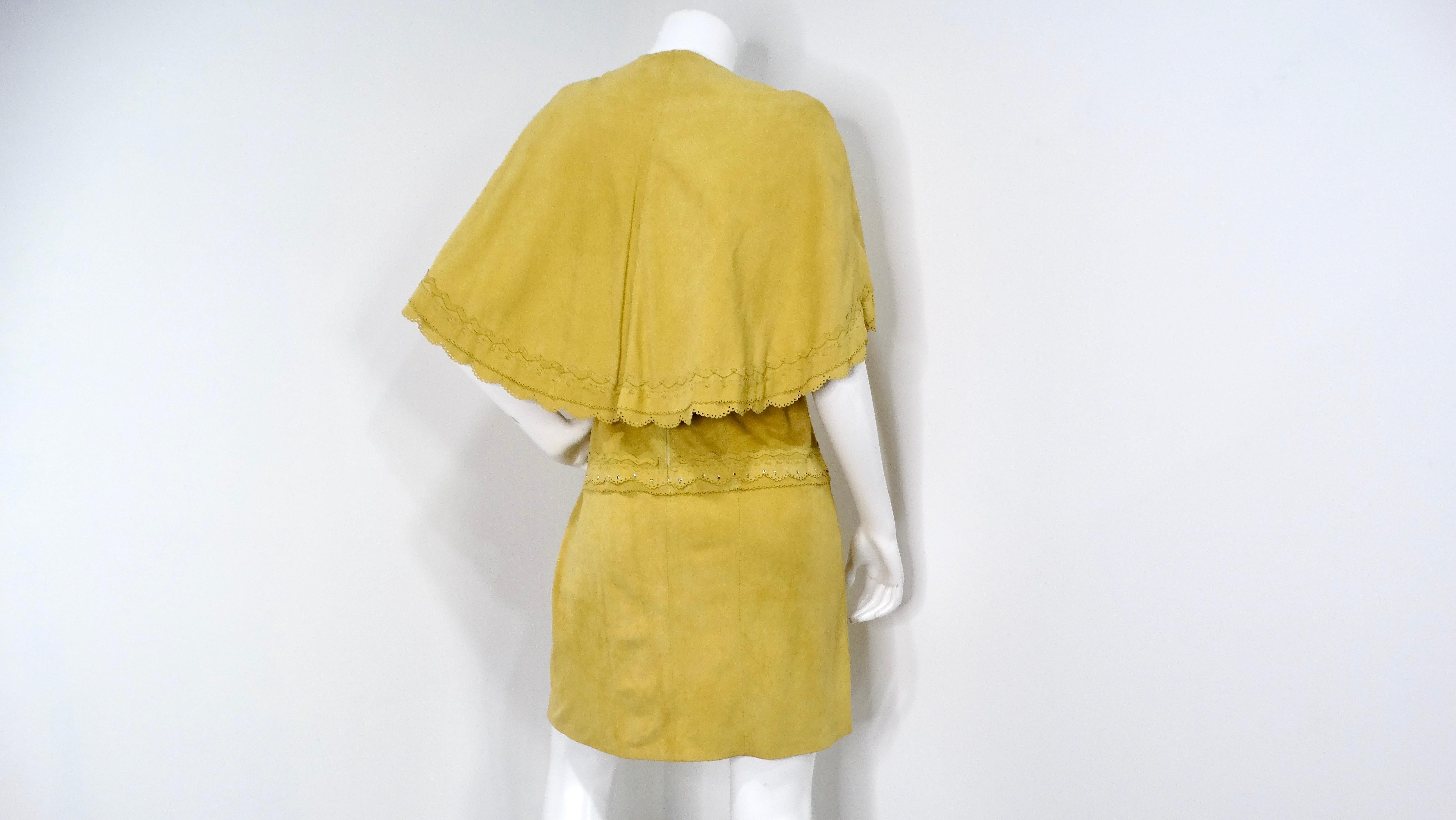 This stunning 1990s yellow suede sleeveless dress is a true vintage gem, perfect for those who appreciate unique fashion statements. The dress features a flattering silhouette in a vibrant mustard yellow, complemented by a matching capelet that