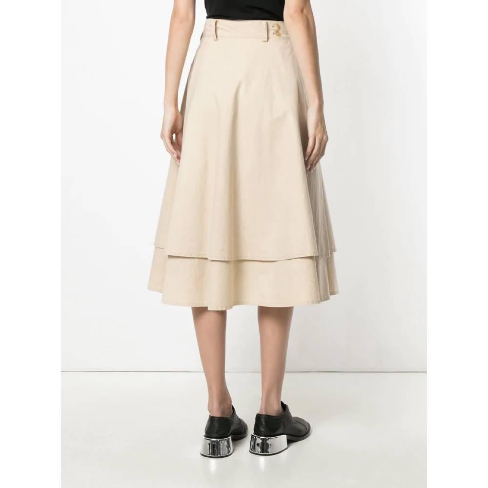 Yohji Yamamoto double layer skirt in beige cotton, with medium waist, with belt loops at the waist and adjustable closure with buttons. Medium length. 
Years: 90s

Made in Japan

Size: 36 FR

Linear measures:

Lenght: 76 cm