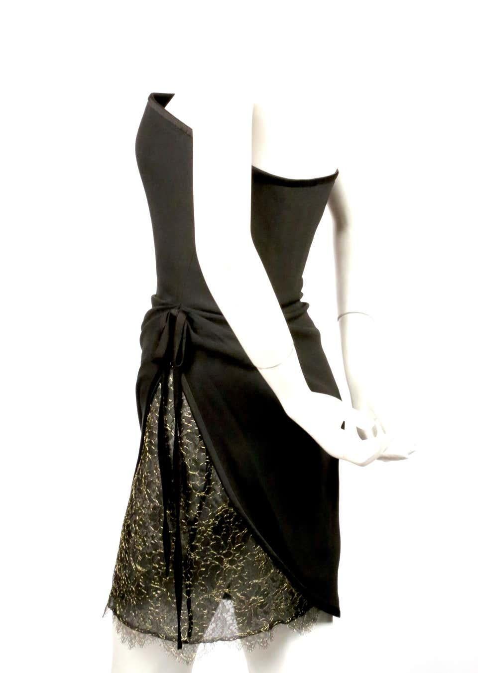 Jet-black, strapless dress with asymmetrical draping and lace accent designed by Yves Saint Laurent dating to the early 1990's. Labeled a French size 38. Dress best fits a US 2 or slim 4. Approximate measurements: bust 33