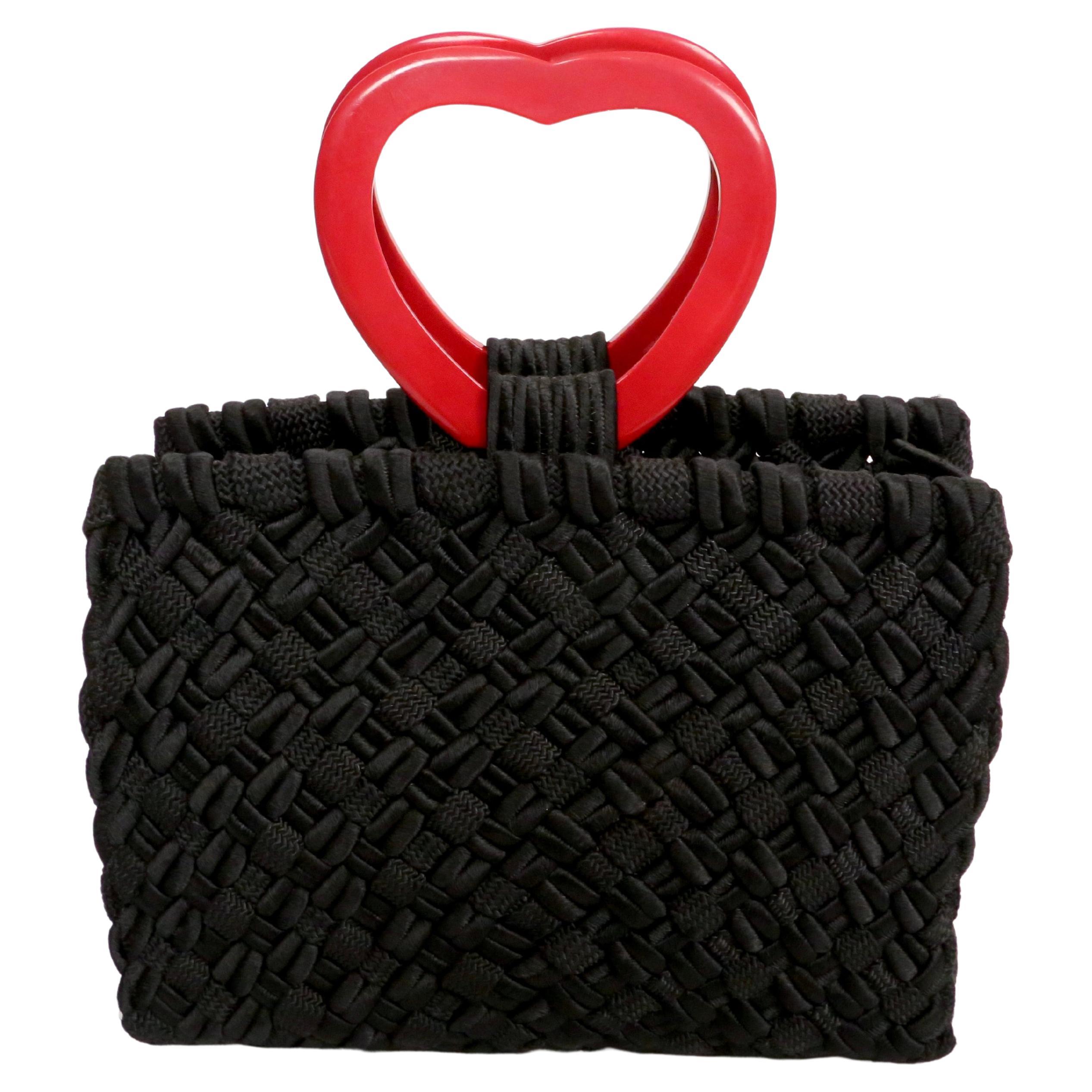 Very rare, jet-black woven passementerie bag with red heart handles from Yves Saint Laurent rive gauche dating to the 1990's.  Approximate measurements: 9.25