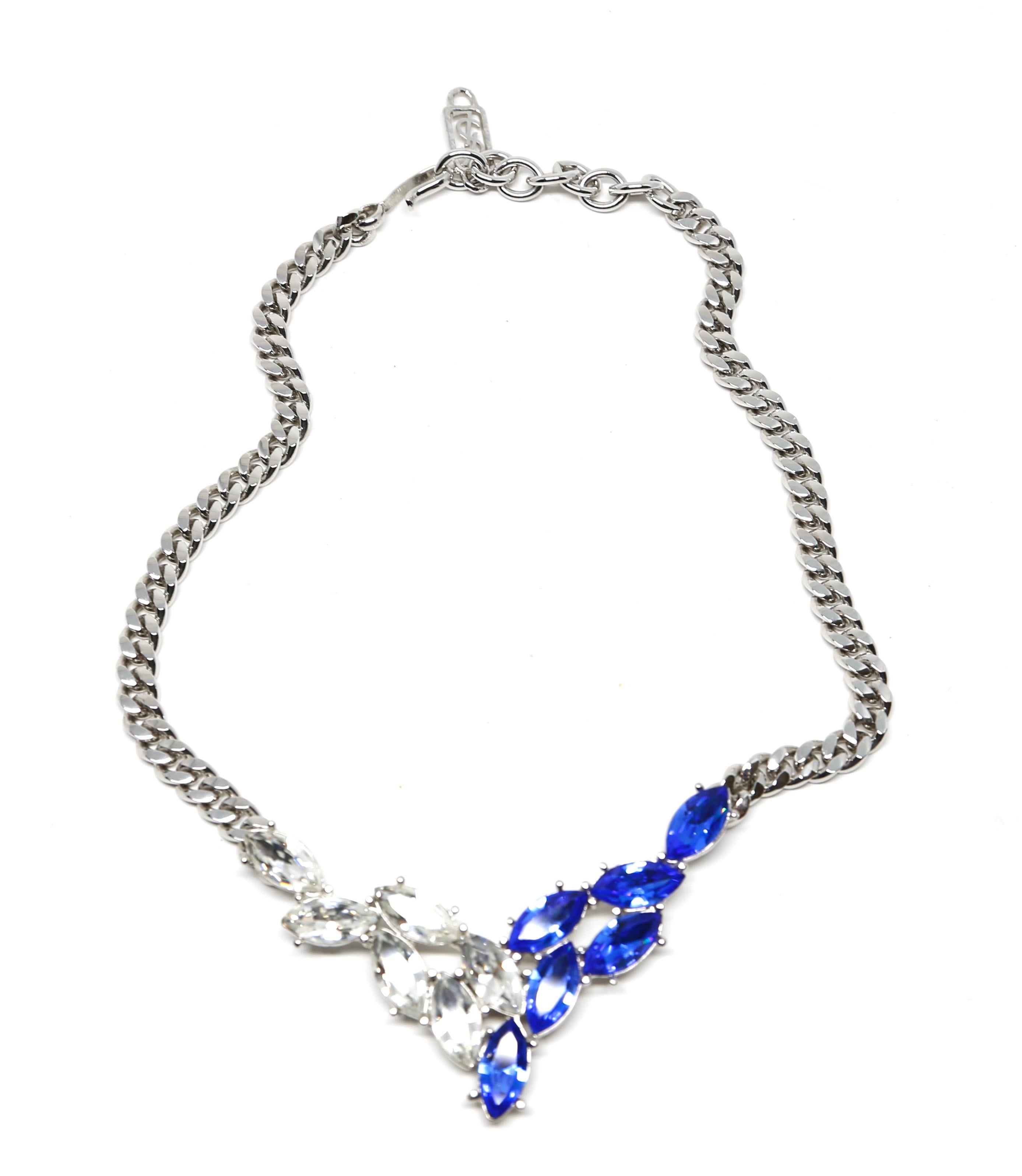 Striking, blue and clear faceted crystal necklace set in silver-tone metal designed by Yves Saint Laurent dating to the 1990's. Measures approximately: 18