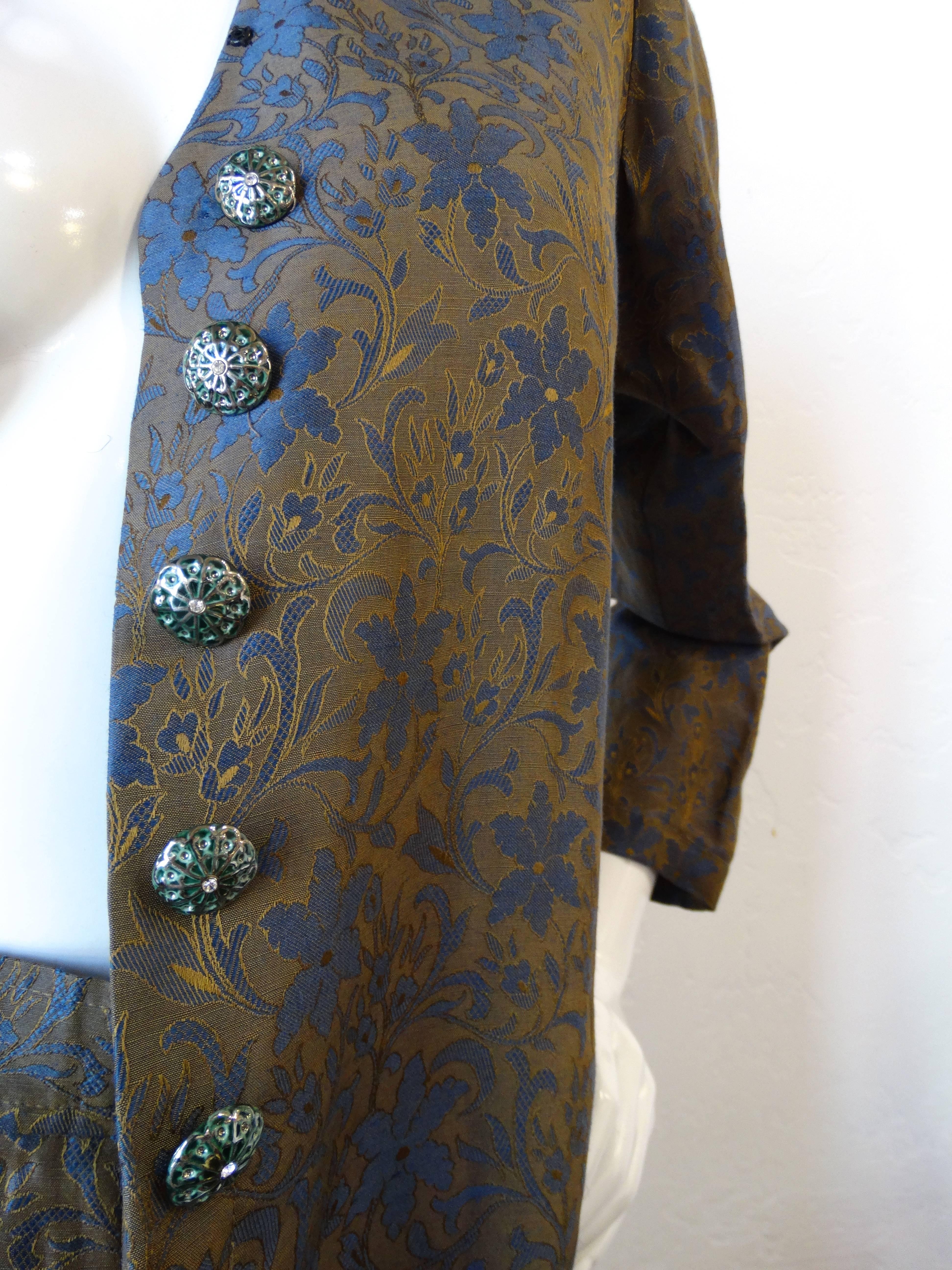 Matching suit sets are so en vogue! Have your own matching moment with our incredible 1990s Yves Saint Laurent brocade suit set! Made of a silk blend brocade fabric in contrasting shades of blue and tan. Buttons up the front with rhinestone