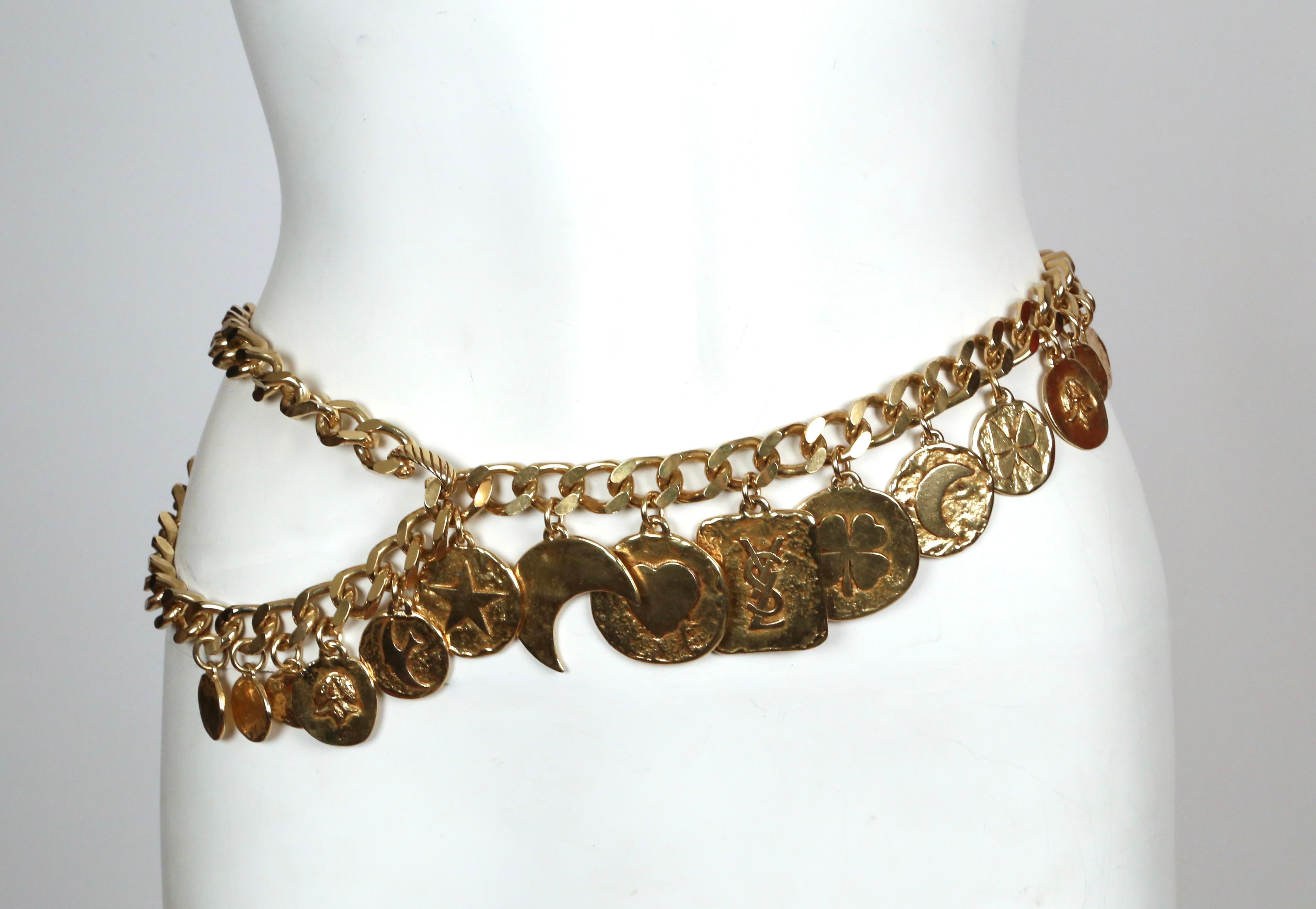 Very rare gilt charm belt designed by Yves Saint Laurent dating to the early 1990's. This fabulous belt features 16 coin charms suspended from a 37