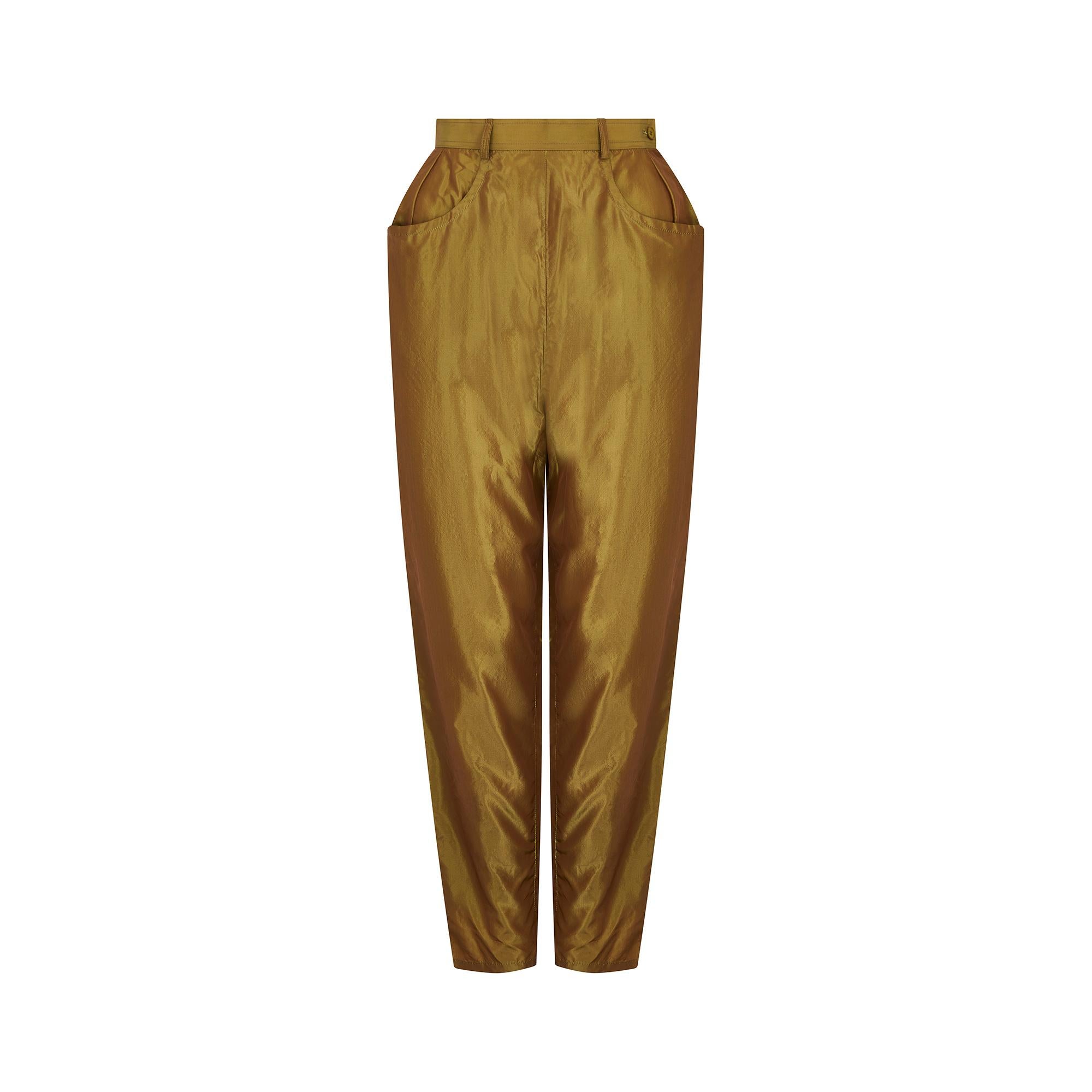 1990s iridescent peg trousers by Yves Saint Laurent from his Rive Gauche line, featuring a fitted high waist and a side zip with top button closure. The fabric is a soft 100% silk, with an iridescent shine that fluctuates between khaki, olive and