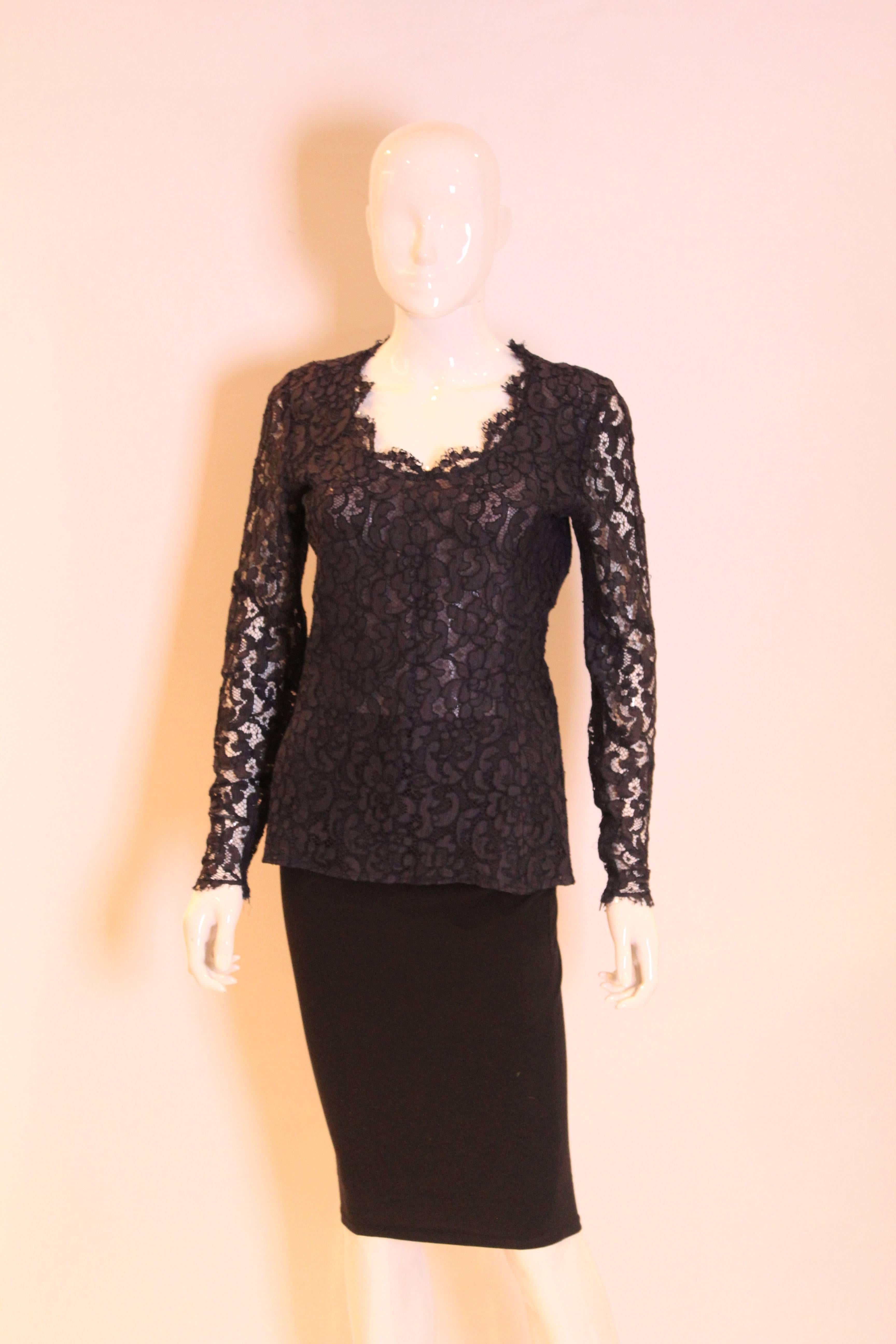 An elegant navy lace top for summer from Yves Saint Laurent, Rive Gauche line. The top has a sweetheart neckline, fitted body and long sleeves. The body is lined. The top as a side zip opening, and zip opening at the sleeves.