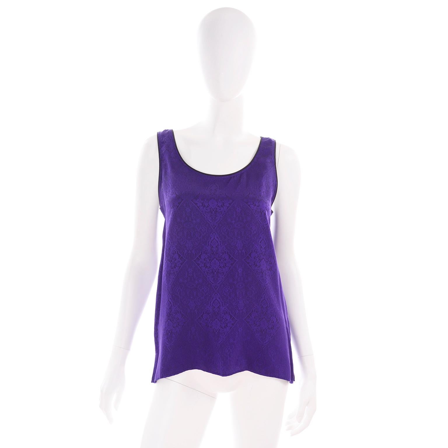 This is a rich purple Yves Saint Laurent silk jacquard sleeveless top with black trim and side slits. The top is labeled a French size 36. Yves Saint Laurent Variation Label and we estimate it to fit a size S/M depending on how you would like it to
