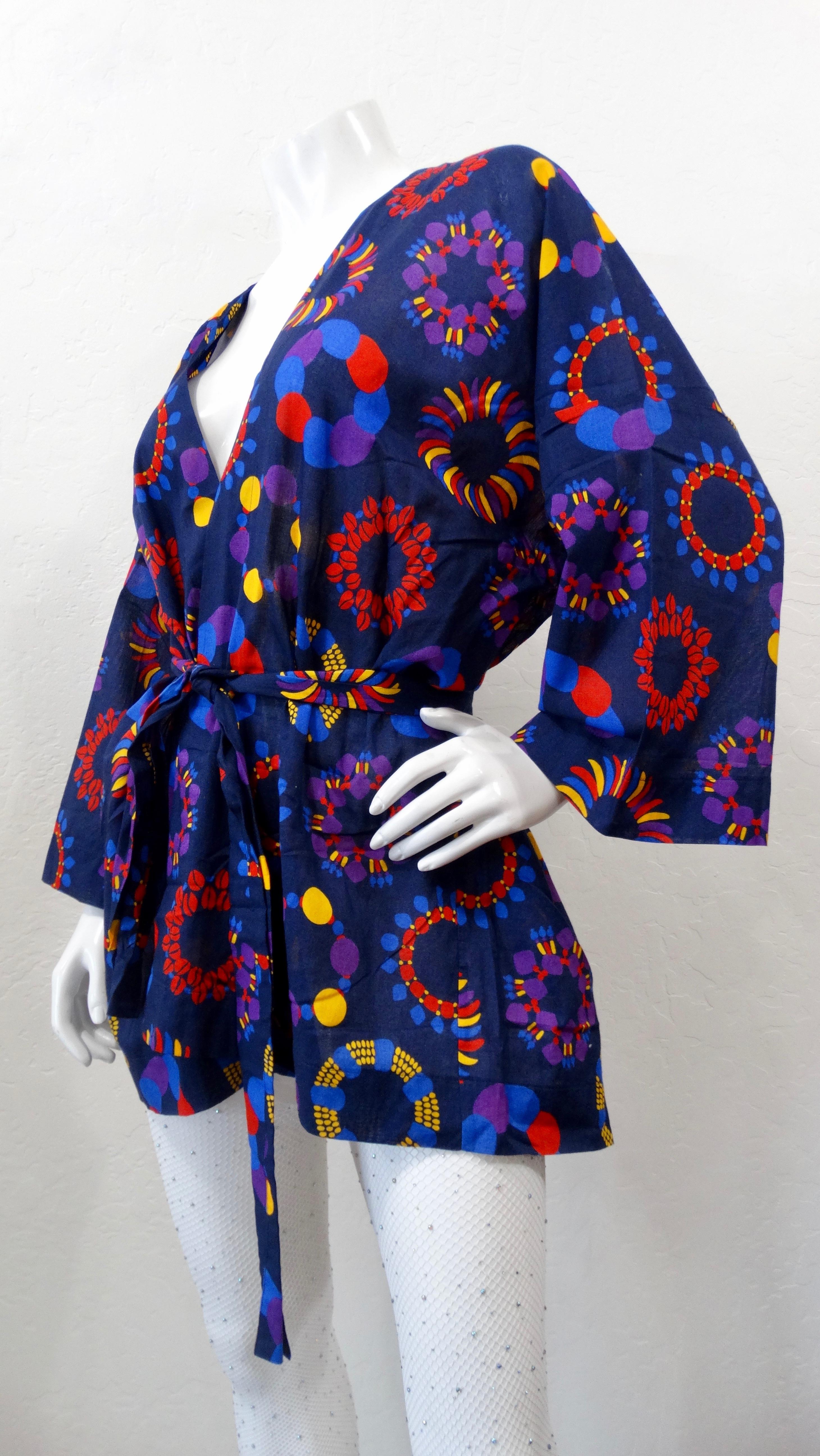 Introduce your wardrobe to this amazing Yves Saint Laurent jacket! Circa 1990s, this short kimono style jacket is a gorgeous cobalt blue and features a contrasting abstract radial pattern. Includes roomy dolman sleeves and a removable waist tie.