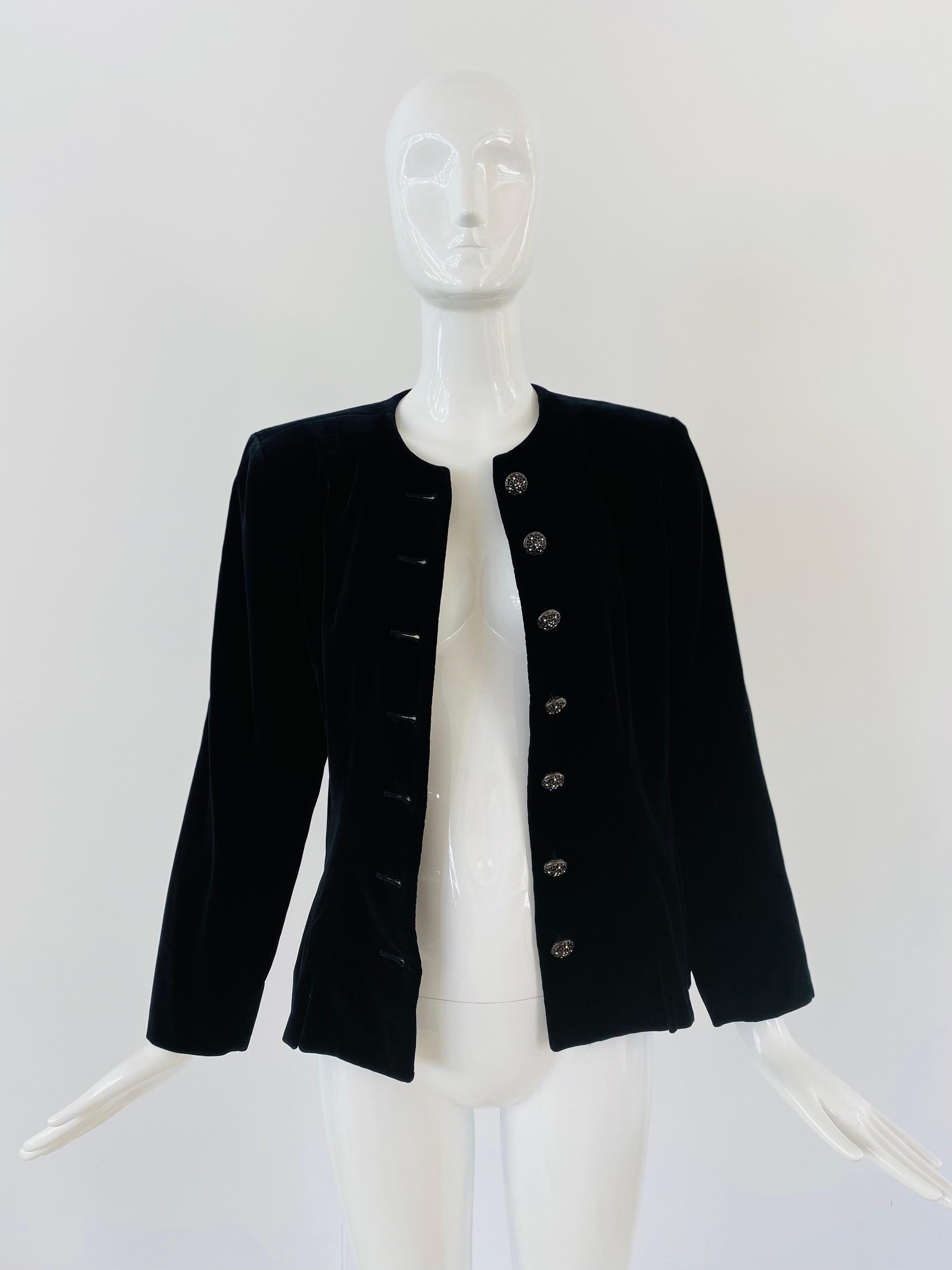 
The early 1990s Yves Saint Laurent Rive Gauche velvet evening jacket is a timeless wardrobe piece that captures the essence of luxury and sophistication. The rich velvet fabric is soft and plush, with a deep, rich black color that exudes elegance