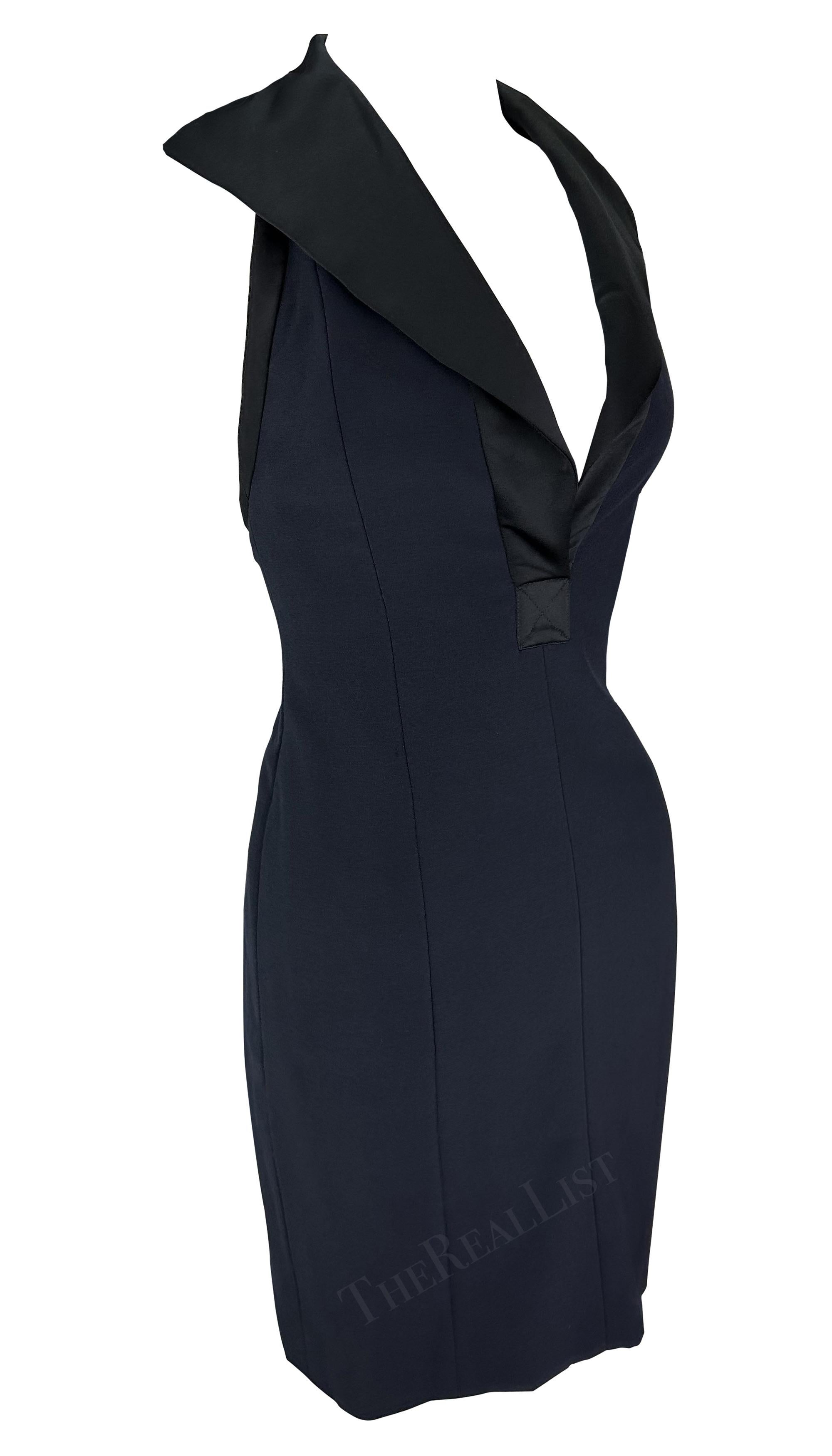 Presenting a fabulous navy blue Yves Saint Laurent halterneck mini dress, designed by Yves Saint Laurent. From the late 1990s, this gorgeous YSL dress features a plunging neckline, an oversized black fold-over collar, an exposed back, and a halter