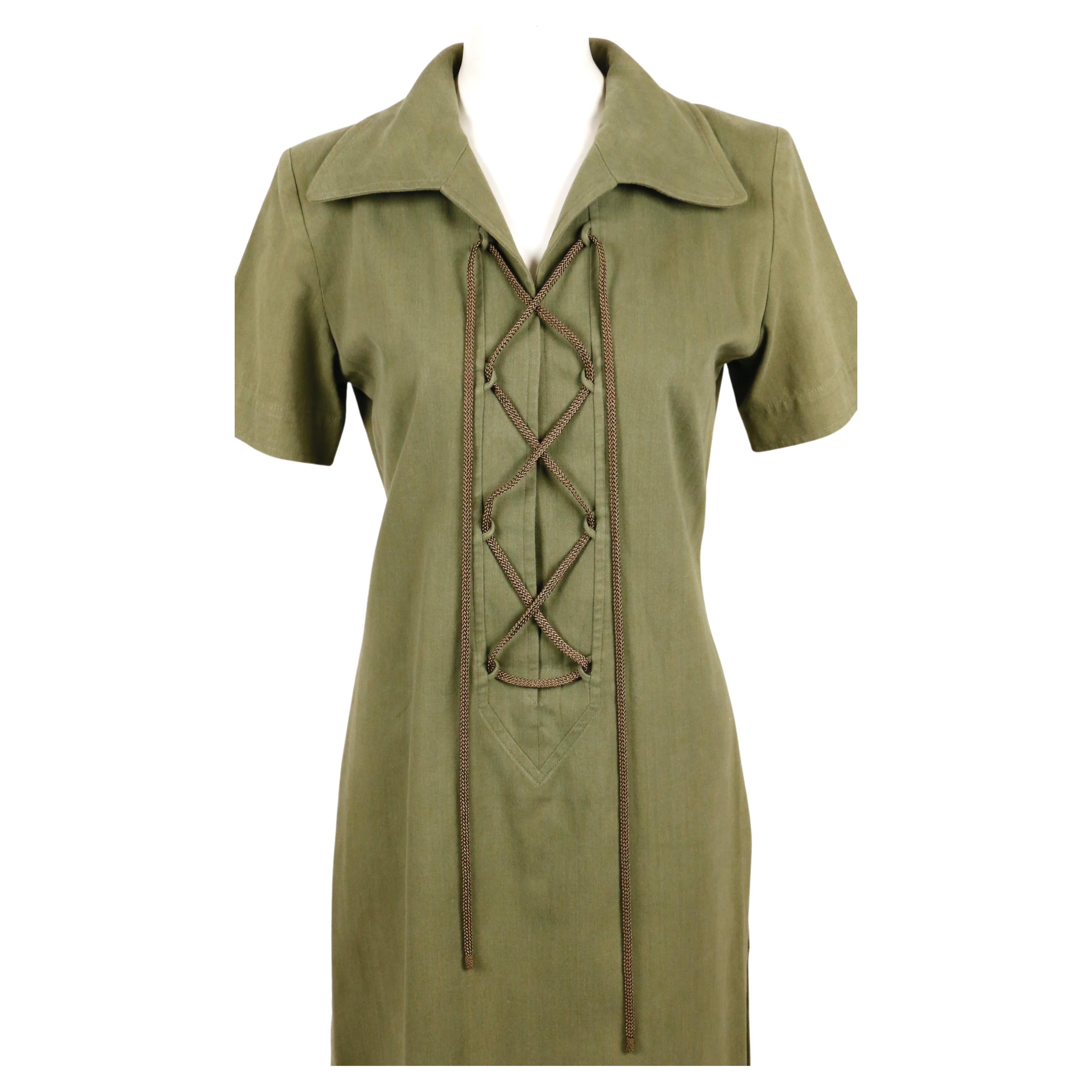 Army-green, cotton safari dress with lace up front and thigh slit designed by Yves Saint Laurent dating to the 1990's. No size is indicated however this fits a S or M (French 38). Approximate measurements: shoulder 15.5
