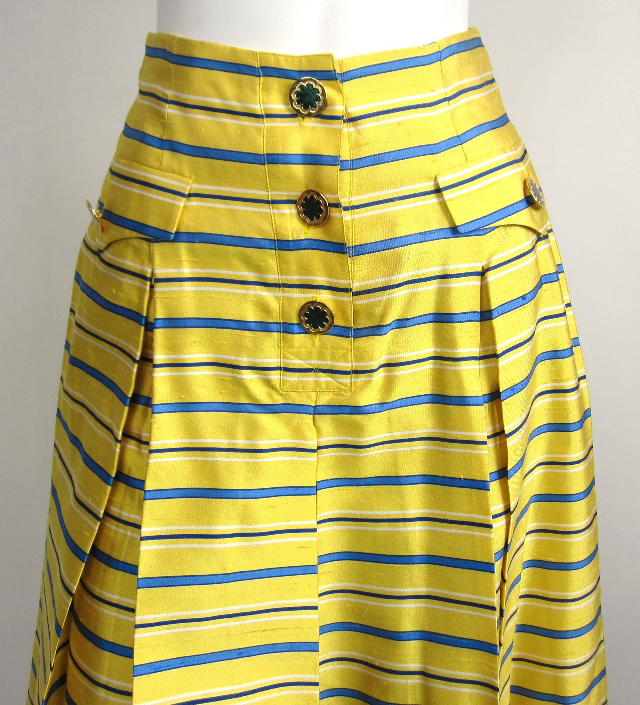 Stunning Yellow and blue striped YSL skirt with gold-tone buttons. The extra button still attached inside the skirt. I have the blouse that matches this skirt on our storefront. Labeled a size 34  Will fit a size small, please check measurements.