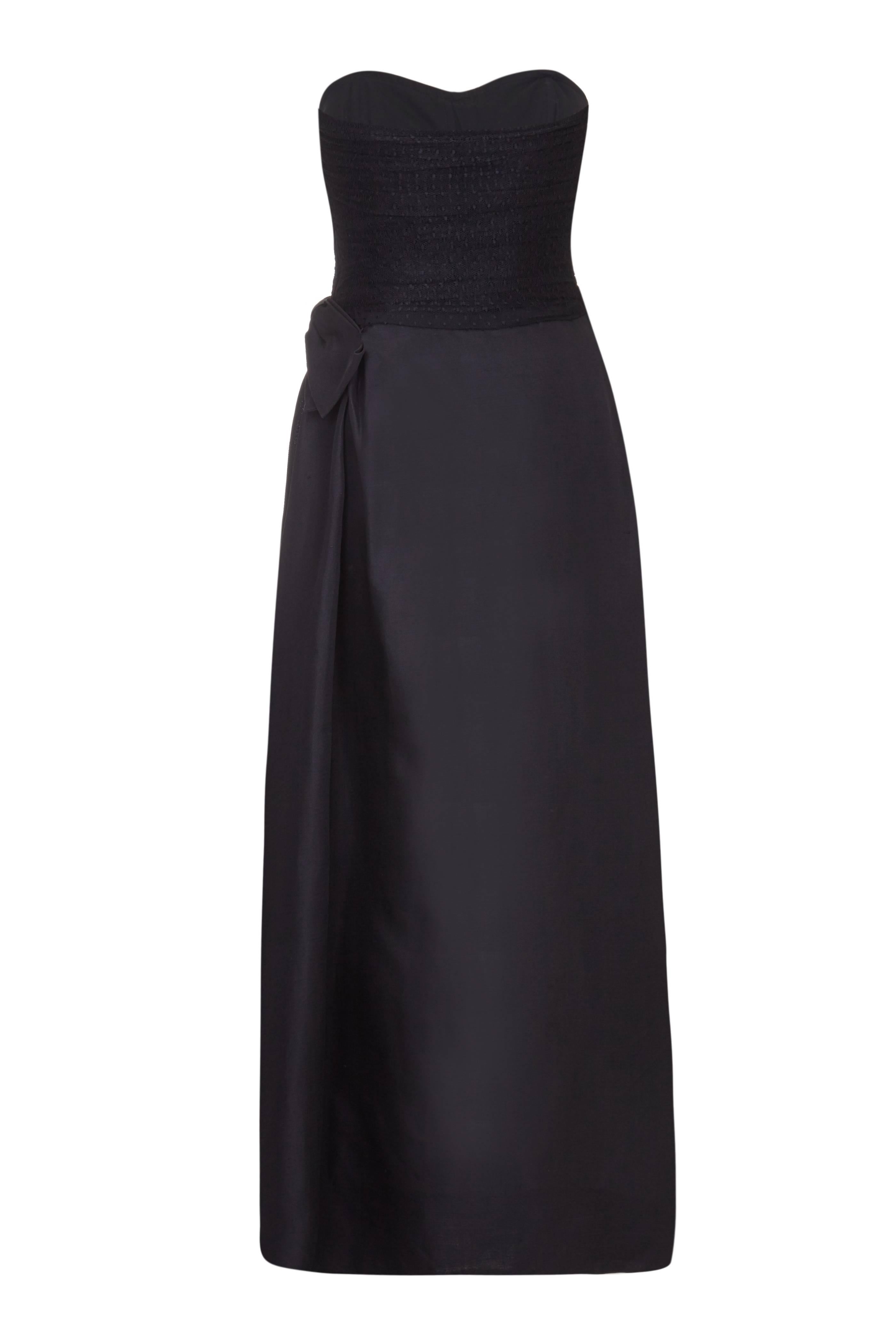 This show-stopper of a gown from Yves Saint Laurent dates back to 1987. A truly stunning strapless dress that could easily become your go-to black evening dress, it is in the details that this dress really shines. Adorned with layereds of frothy