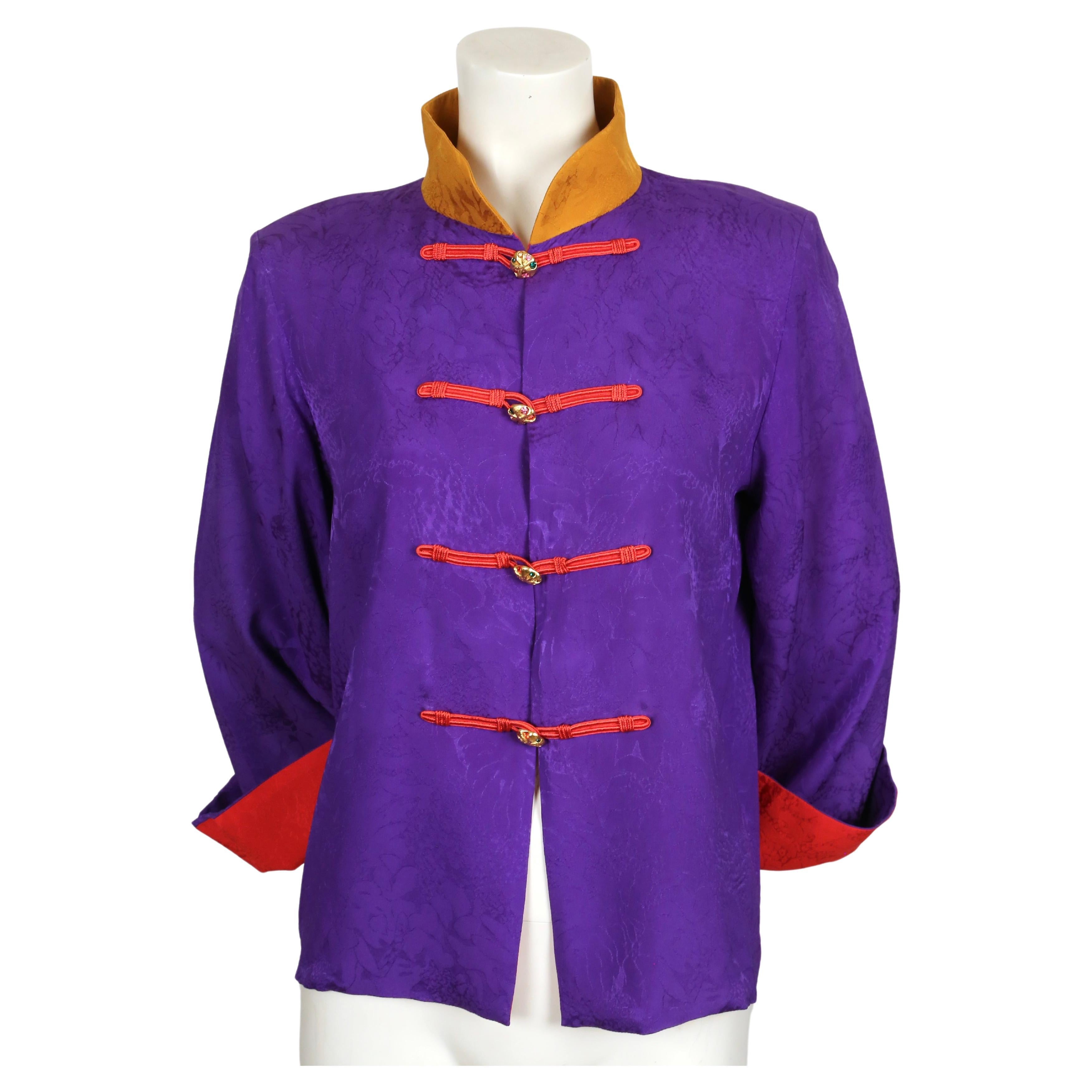 Vibrant purple, mustard and red silk jacket with decorative frog closure and vivid rhinestone buttons. The jacket features a boxy cut with a stand-up collar and has a contrast lining so sleeves can be cuffed. Labeled a French size 38.  Best fits a