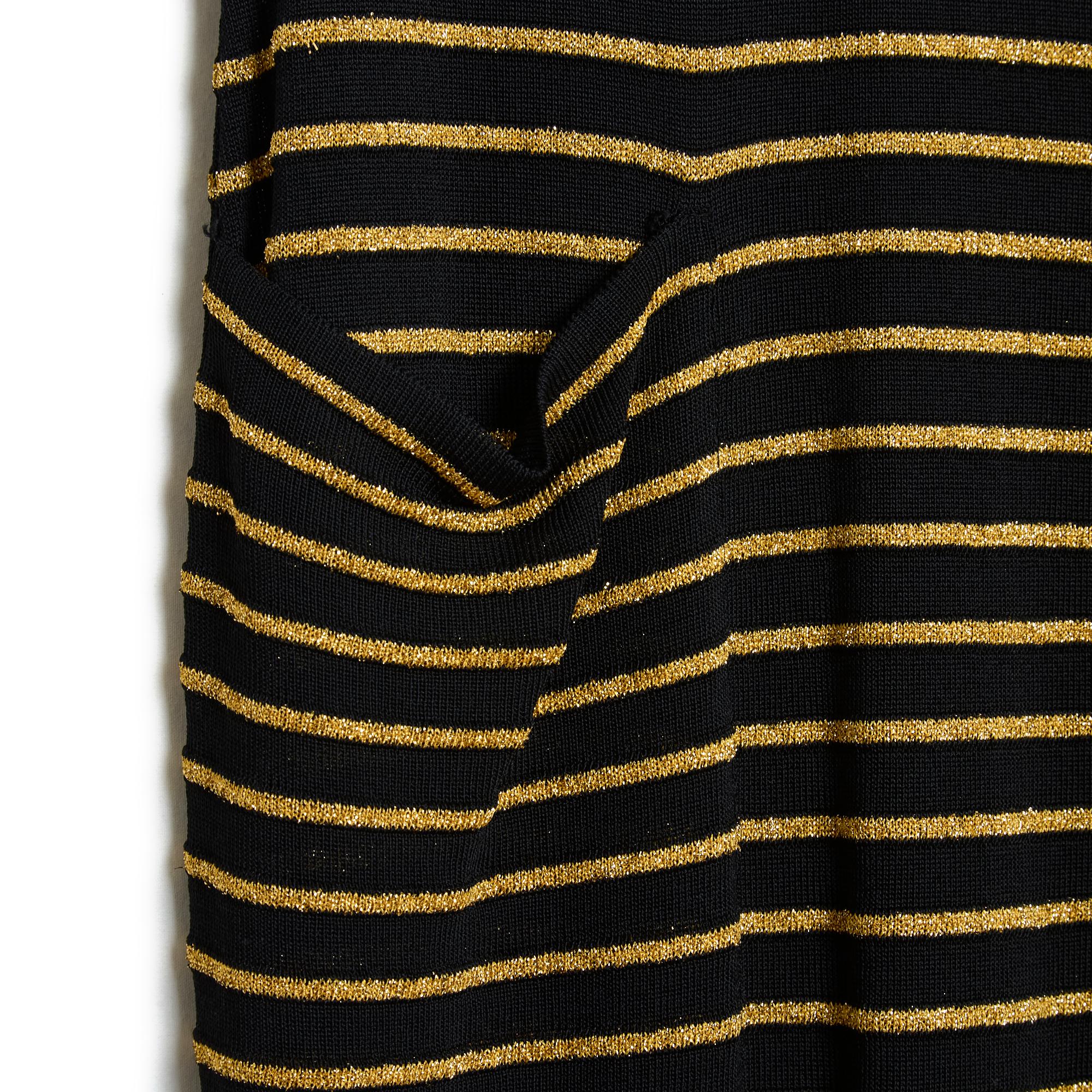 Yves Saint Laurent long dress circa 1990 in black viscose knit striped with gold lurex, wide boat neck, 2 patch pockets on the hips, short sleeves, unlined (therefore slightly transparent). No more material or size label but the measurements (taken