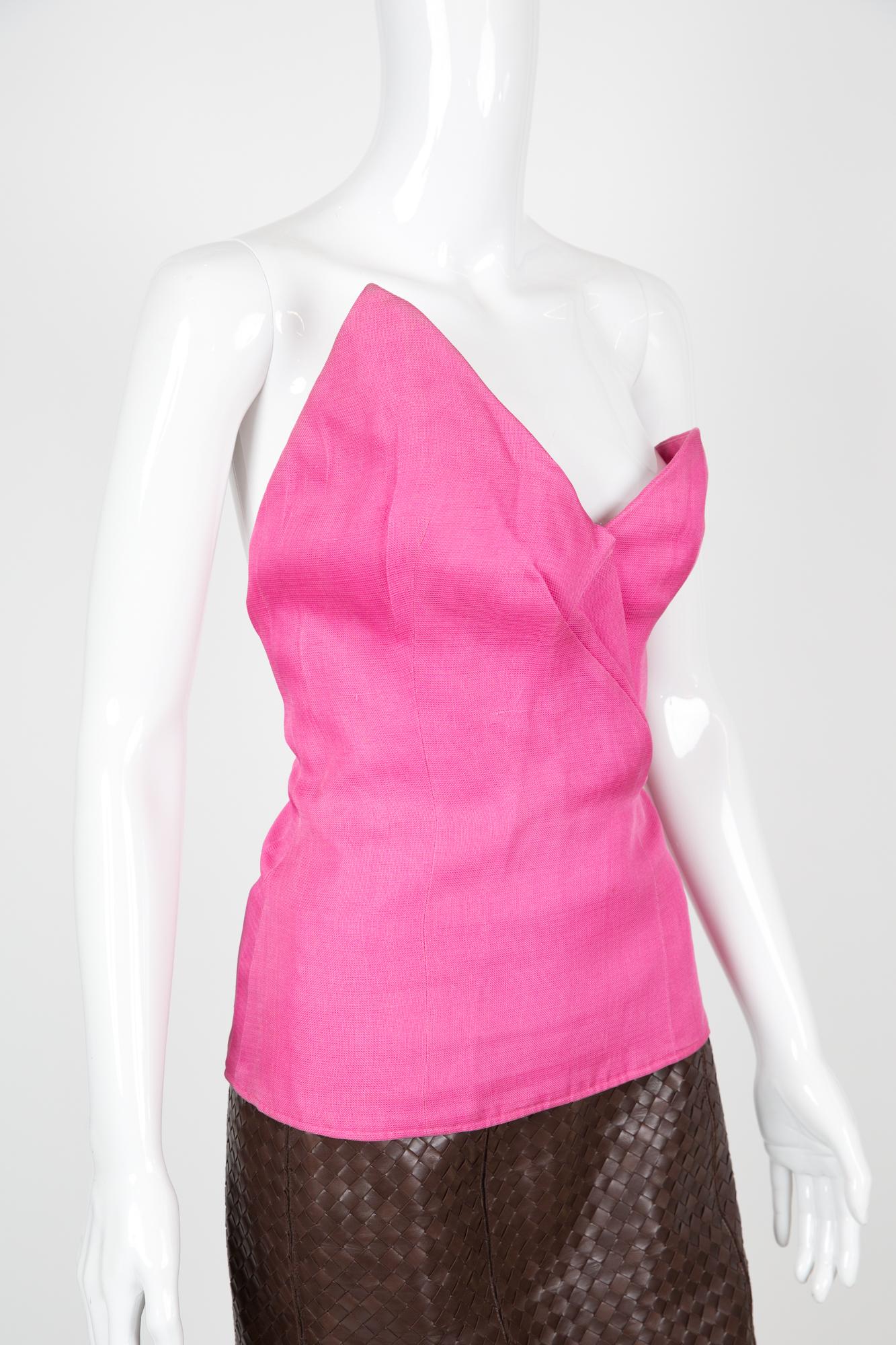 Yves Saint Laurent YSL pink silk asymmetric bustier top featuring an asymmetric front part, inside an attached belt, side zip opening, front pleats details.
Circa 1990s
Composition: 100% silk
Label size 36fr/ US4/ UK8
Made in France. 
In good