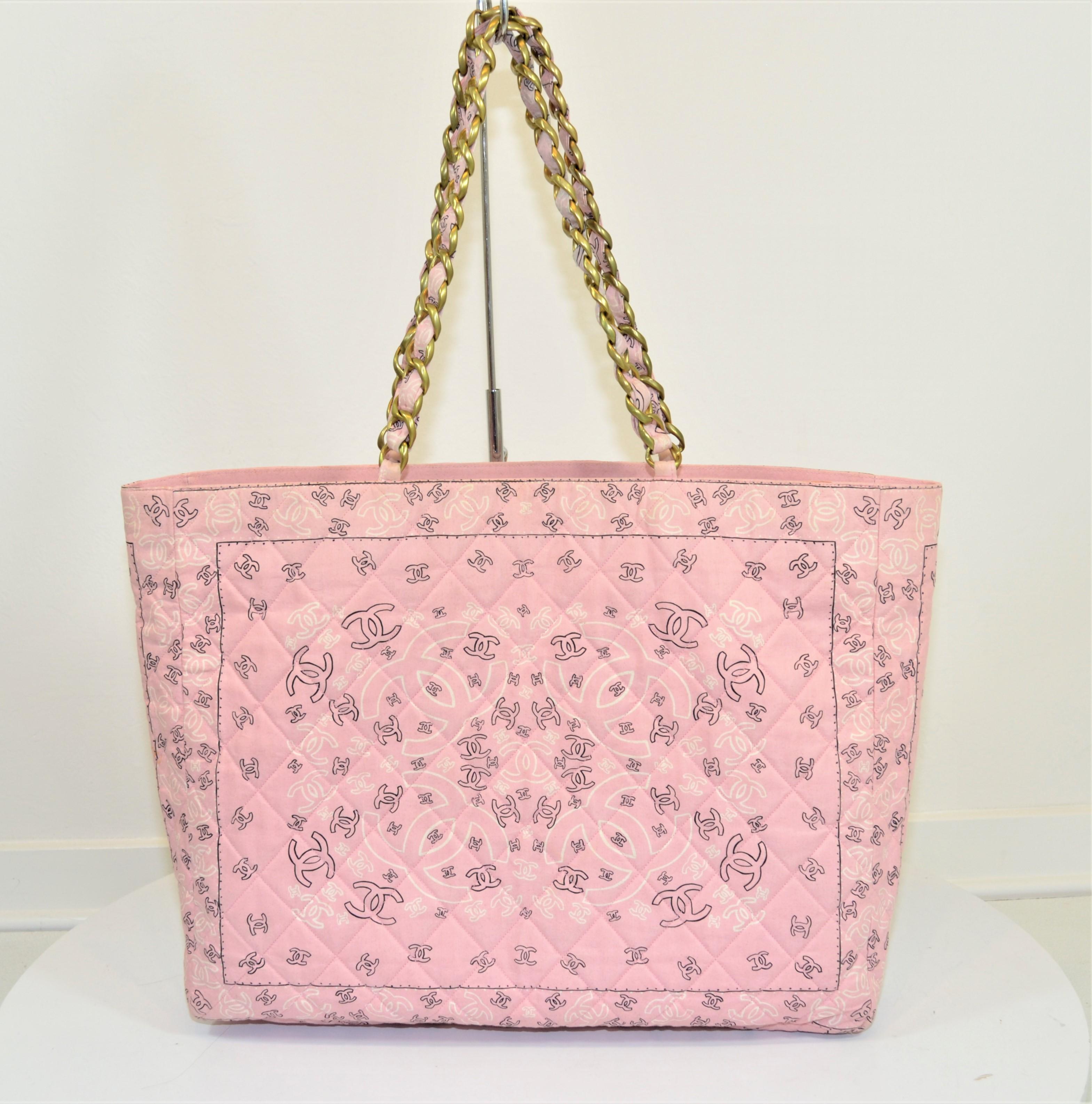 Vintage Chanel tote featured in a pink bandana print from 1991-1994 -- canvas bag with faille lining that has one zippered pocket and one slip pocket, brushed gold-tone hardware. Made in France. Tote has normal wears throughout the canvas fabric and