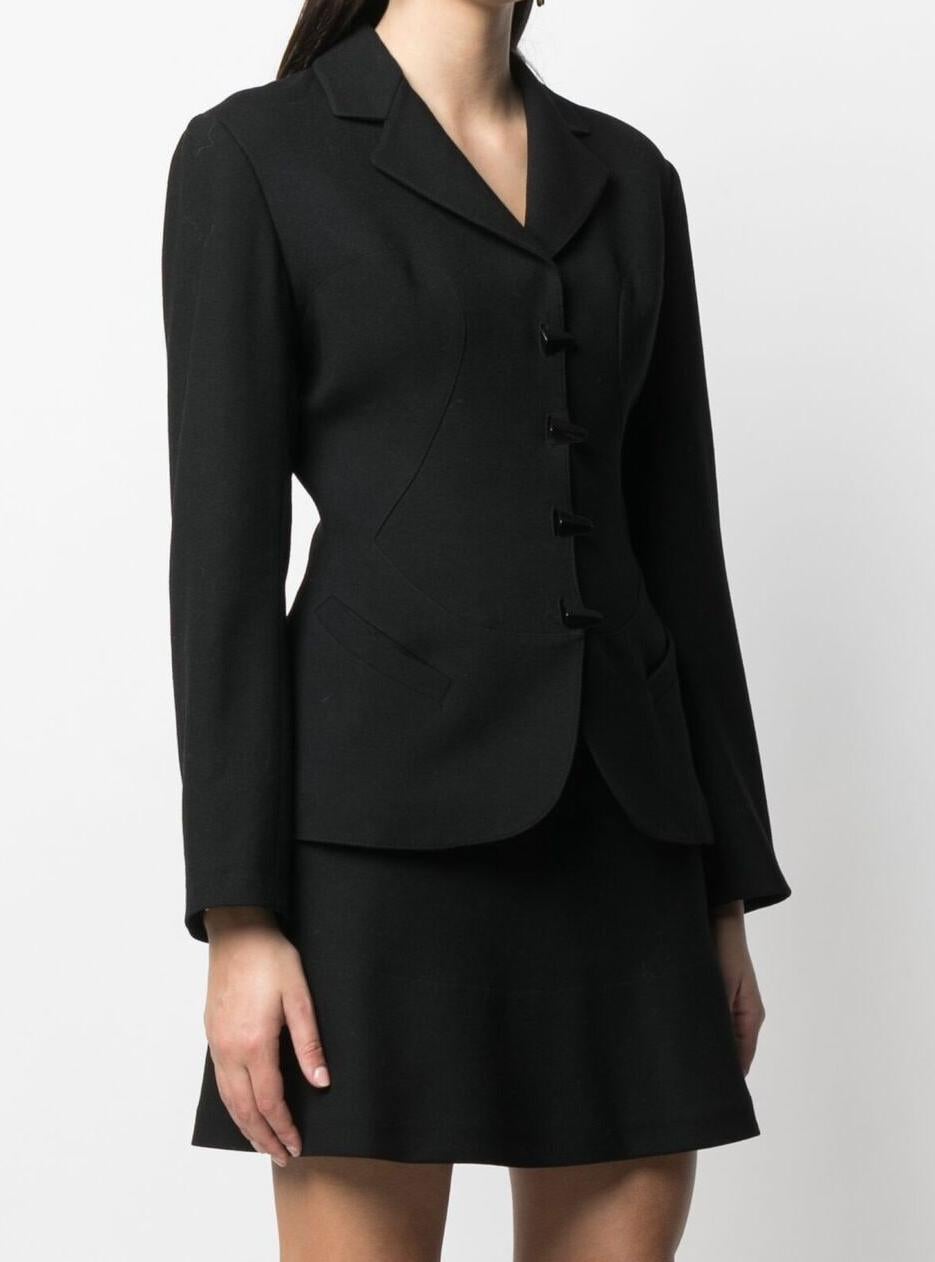 Azzedine Alaia Collection autumn-Winter 1991 tribute to Elsa Schiaparelli black wool skirt suit featuring a jacket with cut out effect, single-breasted hook, printed silk lining with butterflies motives, a fancy skate skirt.
-An identic suit at