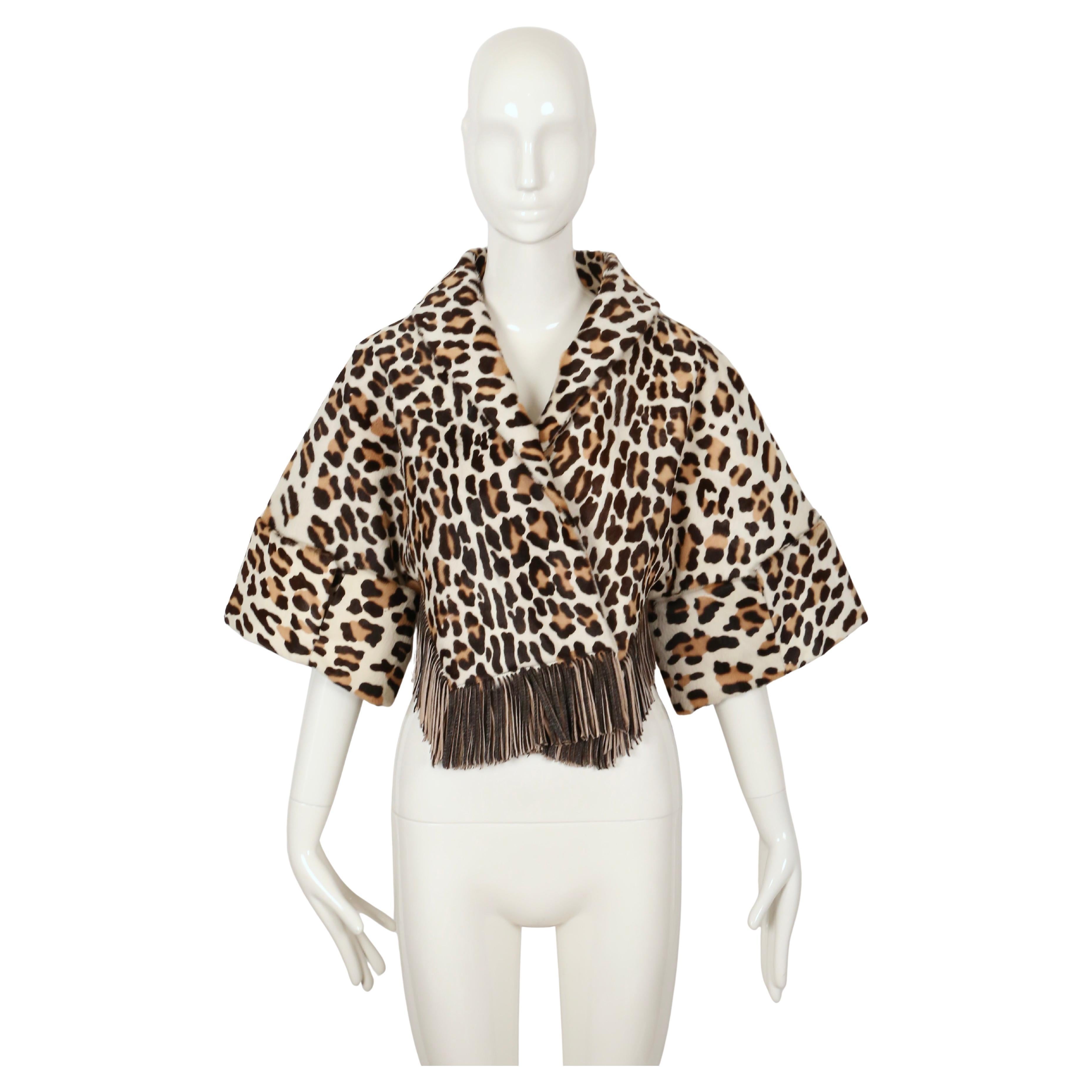 Extremely rare leopard printed calf fur jacket with cropped sleeves and fringed trim designed by Azzedine Alaia dating to fall of 1991. There is no size label although this will bet fit an XS-S. Approximate measurements: empire waist 30.5