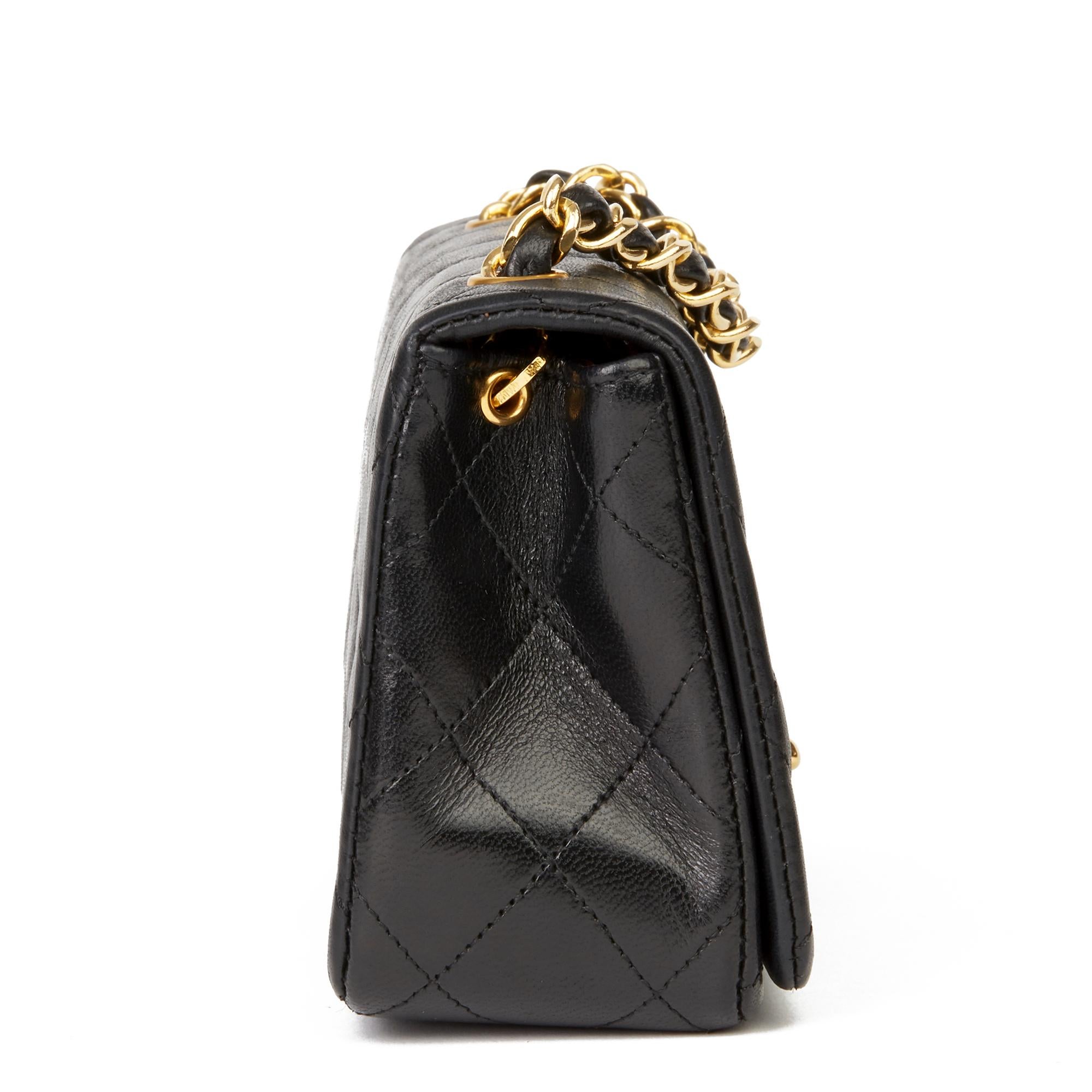 CHANEL
Black Quilted Lambskin Vintage Mini Flap Bag

Reference: HB2813
Serial Number: 1262197
Age (Circa): 1991
Accompanied By: Chanel Dust Bag, Box, Authenticity Card
Authenticity Details: Serial Sticker, Authenticity Card (Made in France)
Gender: