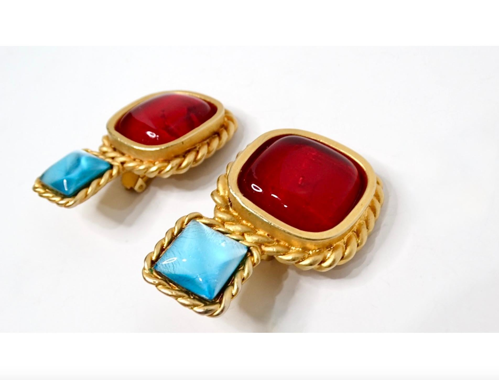 Introducing the stunning 1991 Chanel Statement Red & Blue Cabochon Gold Tone Clip-On Earrings, a quintessential accessory that encapsulates Chanel's timeless elegance and artistic flair. These earrings feature bold red and blue cabochon stones set