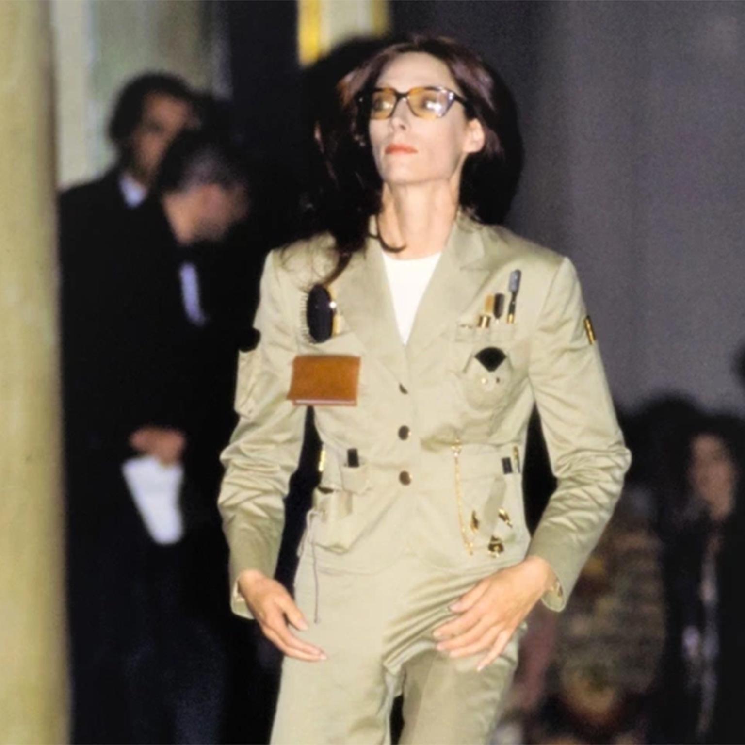 This is a very rare Spring Summer 1991 Franco Moschino Couture Khaki safari style Survival Jacket with tools to survive the urban jungle!  This iconic jacket was featured on the runway in our favorite Moschino show in October of 1990 for Spring /