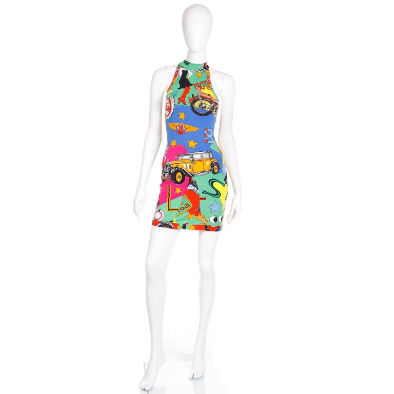 This is a Gianni Versace iconic vintage sleeveless dress in a pop art print featuring betty boop, harley davidson, coca cola, etc. The dress is in a stretch cotton knit in rich shades of hot pink, green, light blue, royal blue, orange/red,