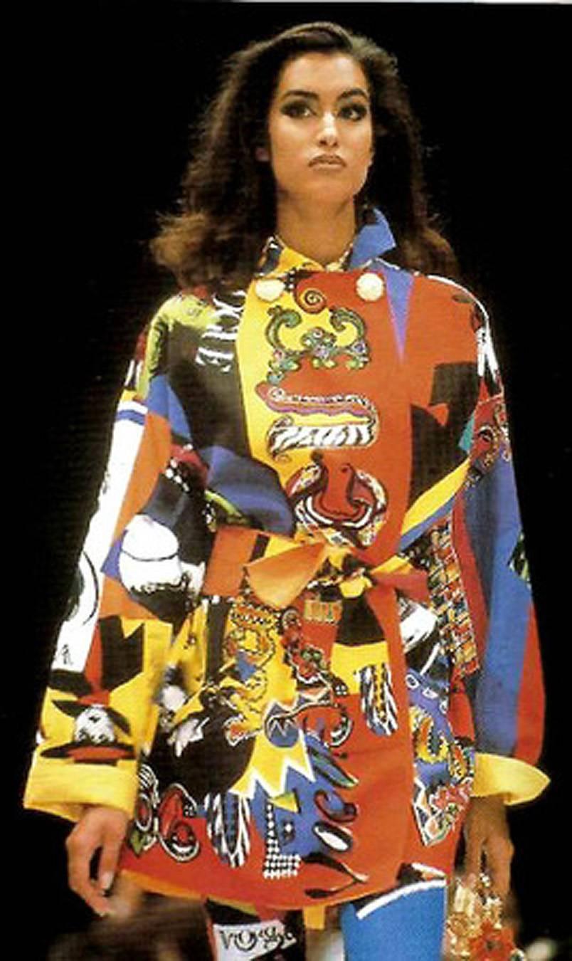 Iconic Gianni Versace Couture colorful novelty Vogue print trench jacket from his documented 1991 runway spring/summer collection. The first Versace boutique was opened in 1978 and its popularity was immediate. Today, Versace is one of the world's