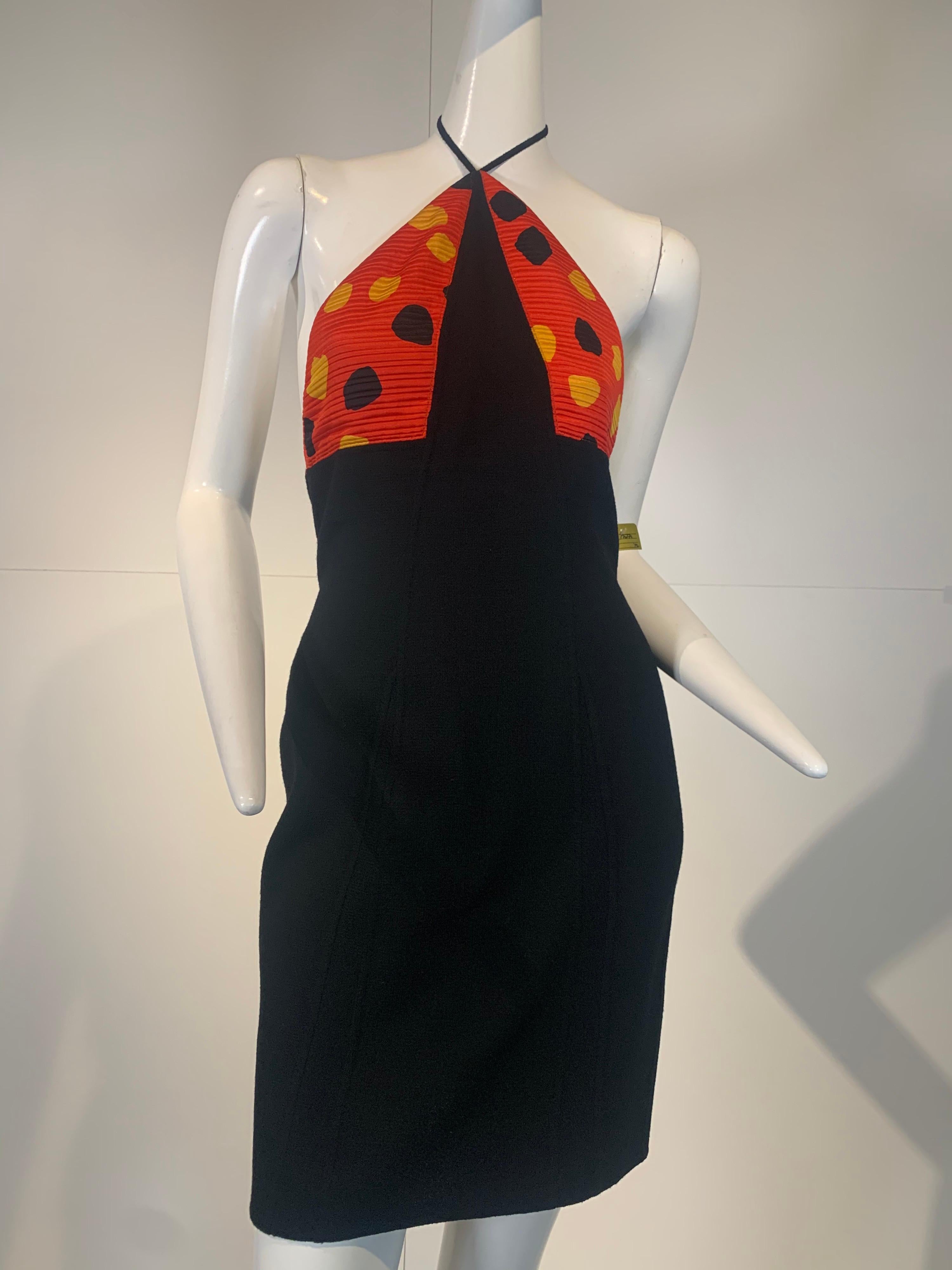 1992 Geoffrey Beene mini dress and bolero jacket ensemble in black silk crepe and pleated red silk with printed pattern of irregular polka-dots in yellow and black: dress has a low-cut back and a spaghetti strap halter bodice. Bolero jacket has long