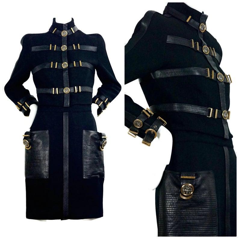 A rare piece of fashion history...

Features:
- 100% Authentic GIANNI VERSACE.
- As seen in FASHION INSTITUTE OF TECHNOLOGY (FIT) Museum collections.
- Black wool blend and leather bondage 2 piece suit.
- Gold and dark silver tone Medusa medallions