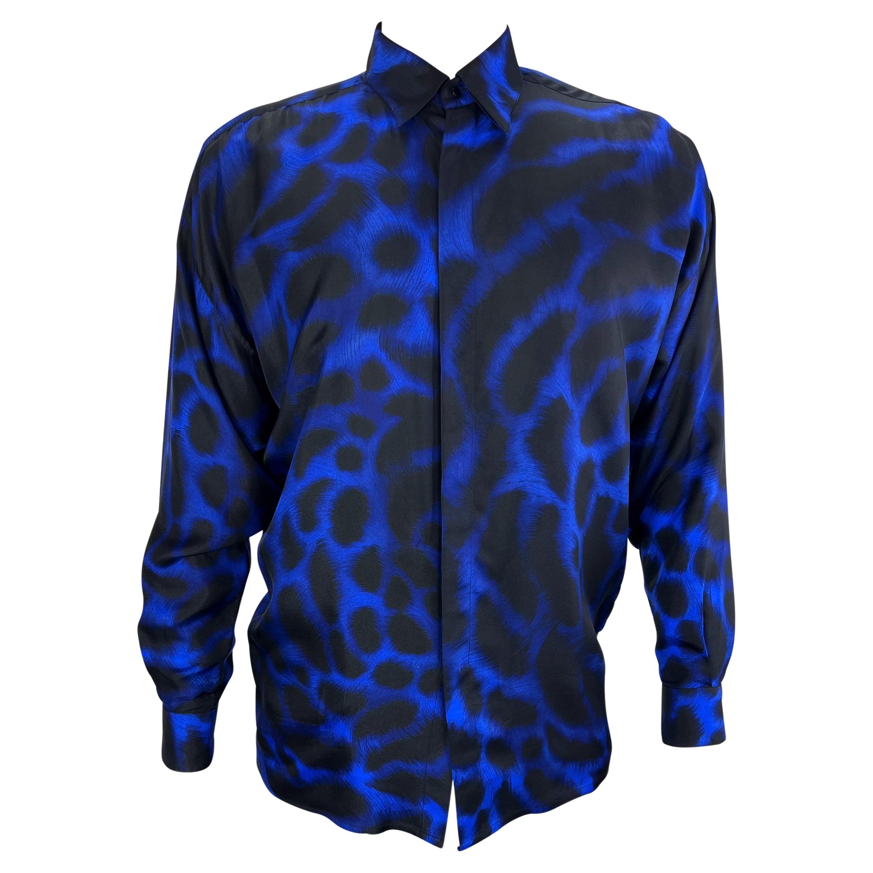 TheRealList presents: an incredible men's silk blue leopard print Gianni Versace shirt, designed by Gianni Versace. From 1992, this amazing and soft shirt features a blue leopard print throughout. This bold shirt is made complete with a front